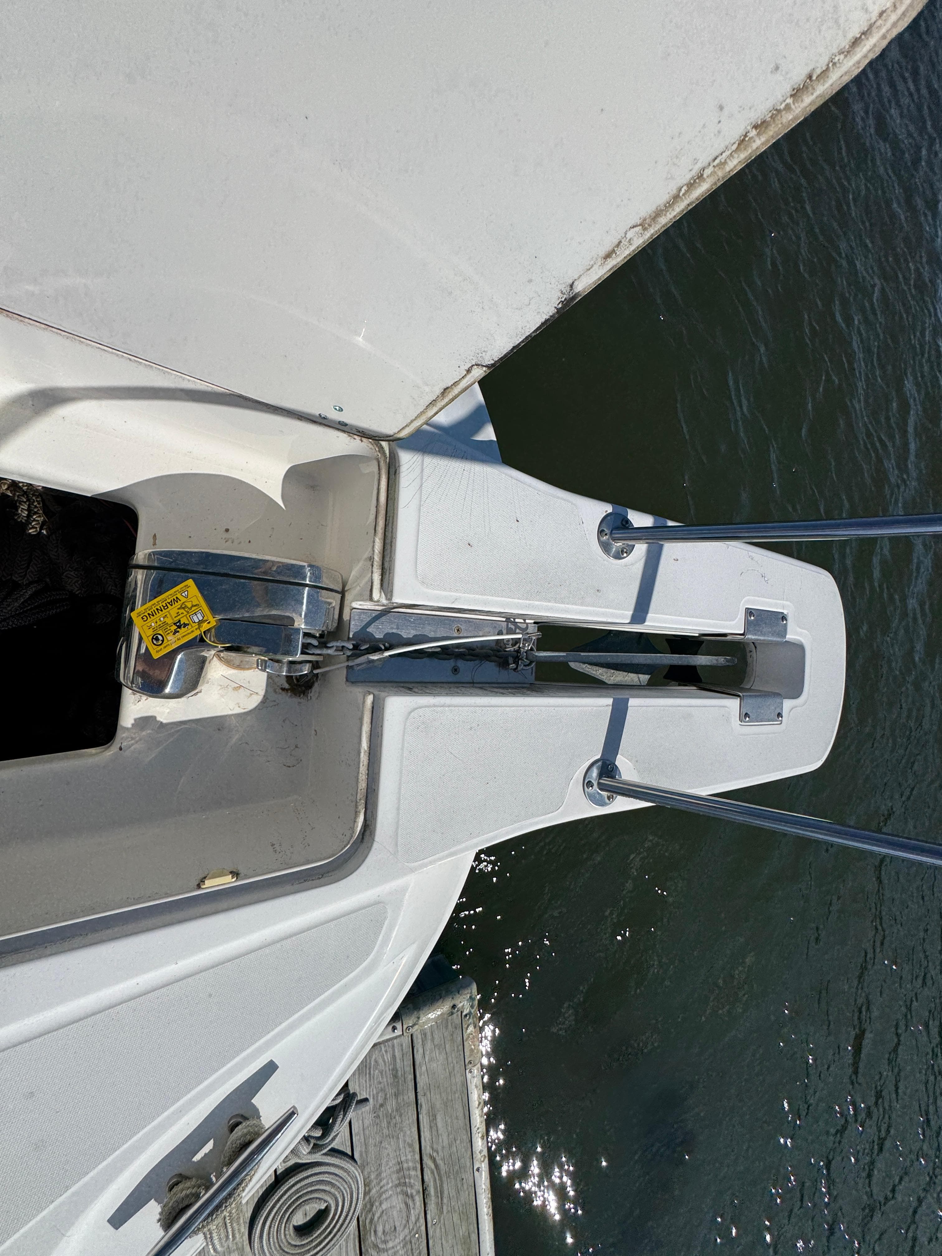 Bow of a 1999 Boston Whaler 28 Conquest boat with anchor and water view.
