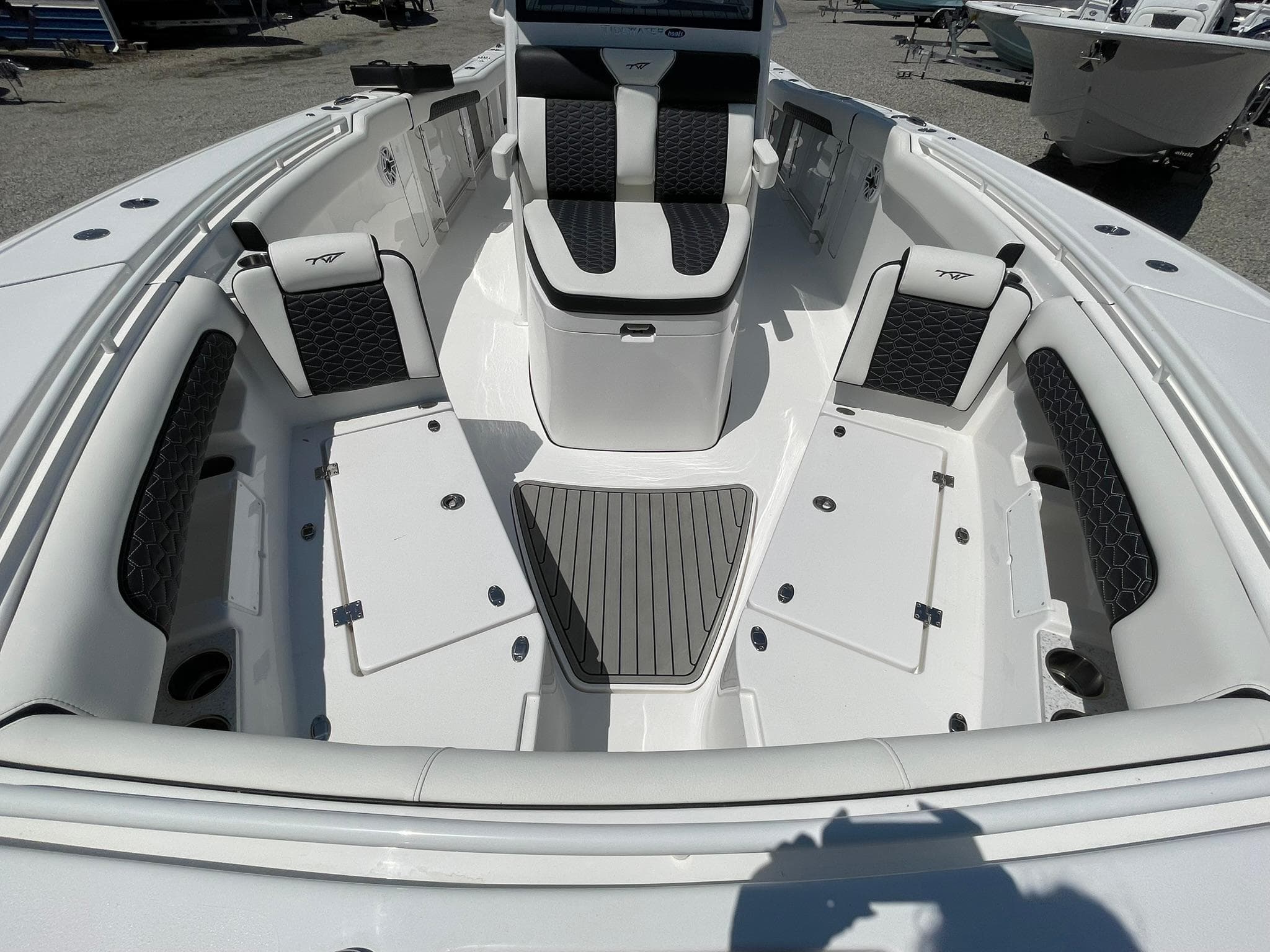 2026 Tidewater 302 CC Adventure boat interior with cushioned seating and storage compartments.
