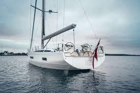 2025 X-Yachts X5.6 sailboat on calm water under cloudy sky.