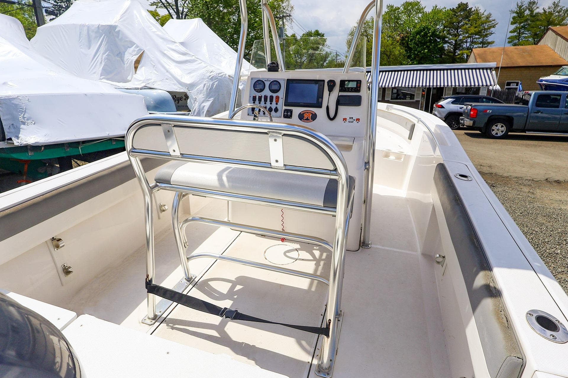 2016 Release 208 RX boat interior with console and seating, parked outdoors.