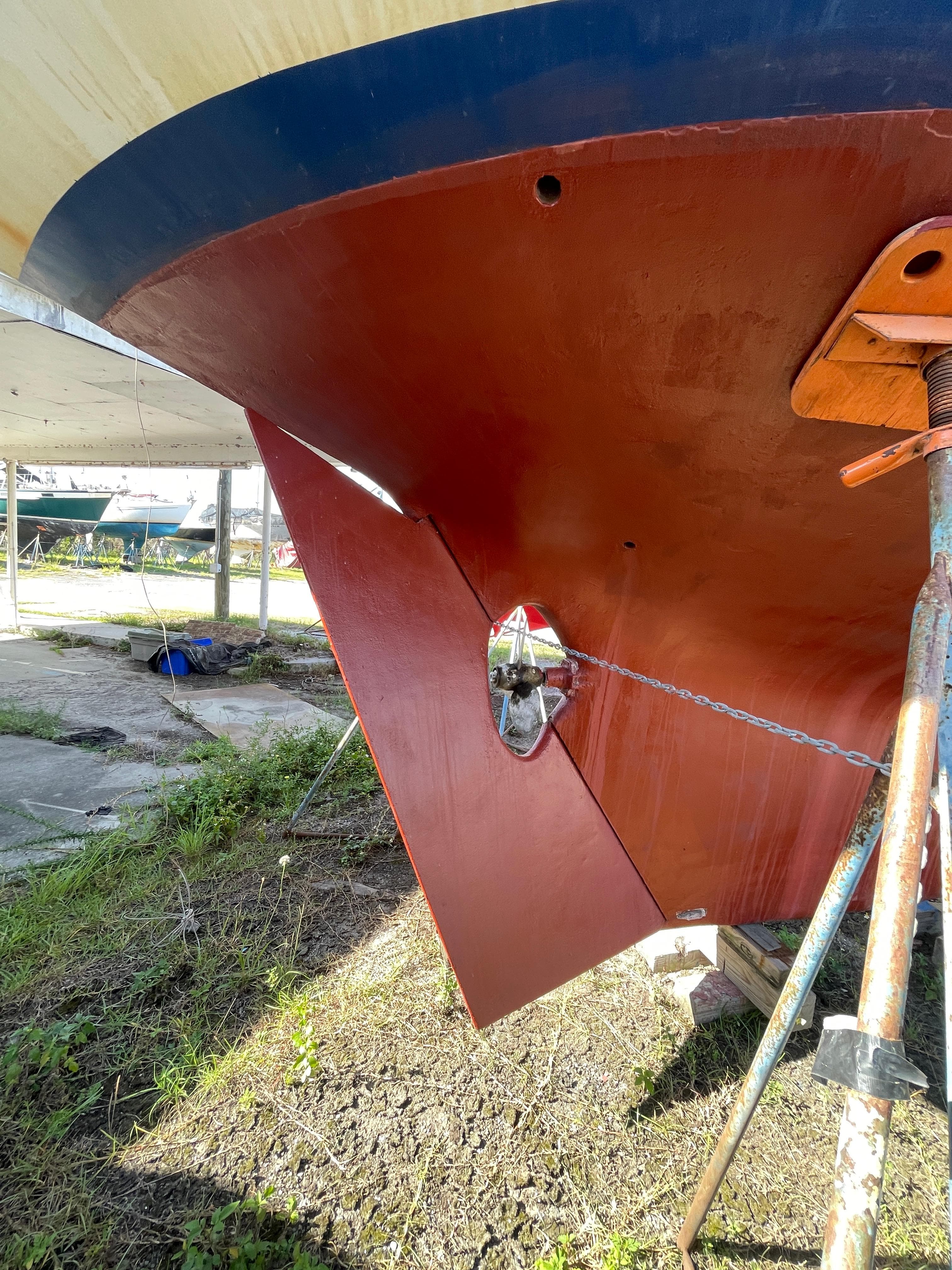 1976 Cheoy Lee Clipper 42 sailboat hull under maintenance, showcasing rudder and propeller.