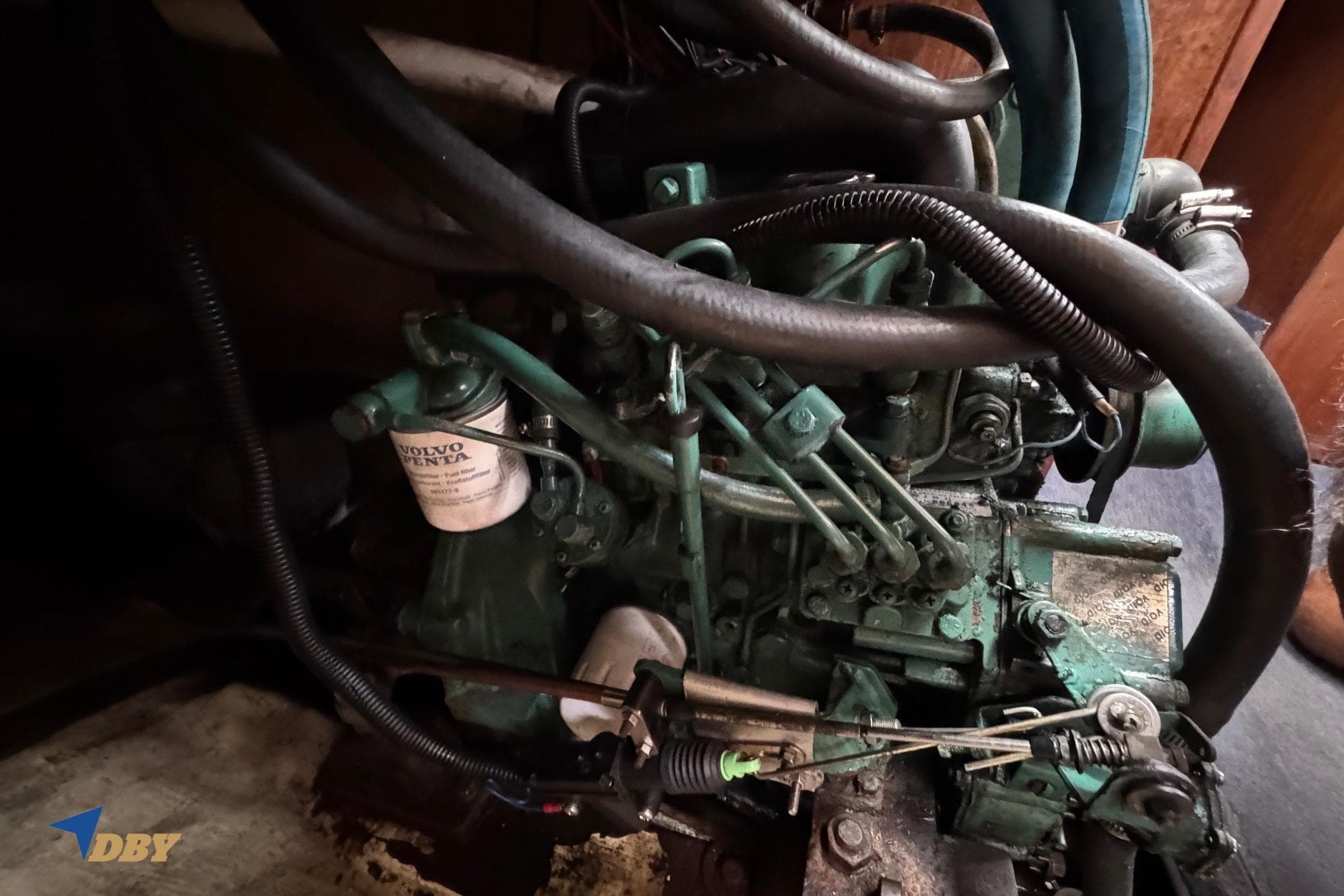 Engine of a 1988 Phantom 33 boat, featuring Volvo Penta components and various hoses.