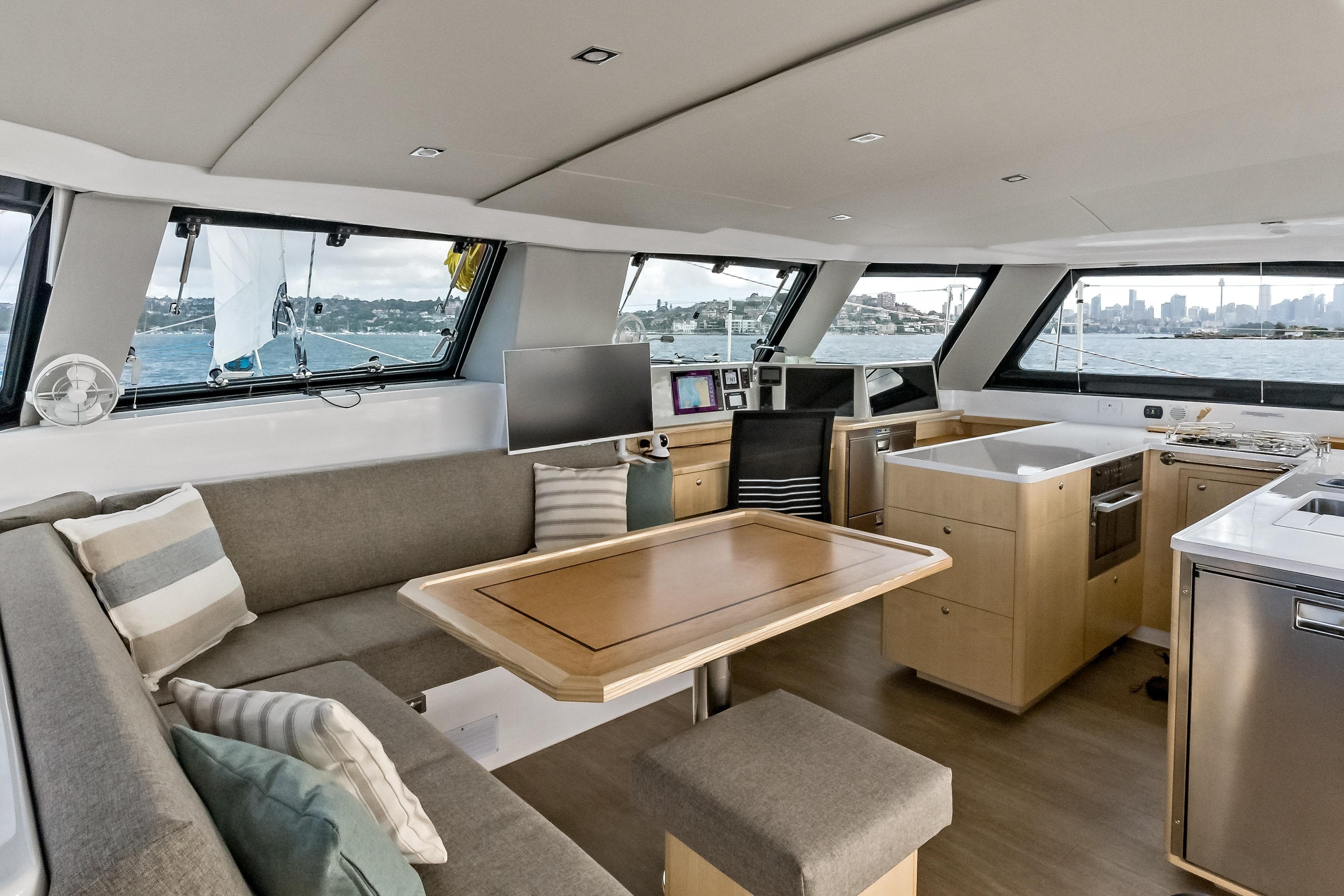 Luxurious interior of 2026 Seawind 1370 catamaran with modern kitchen and panoramic windows.