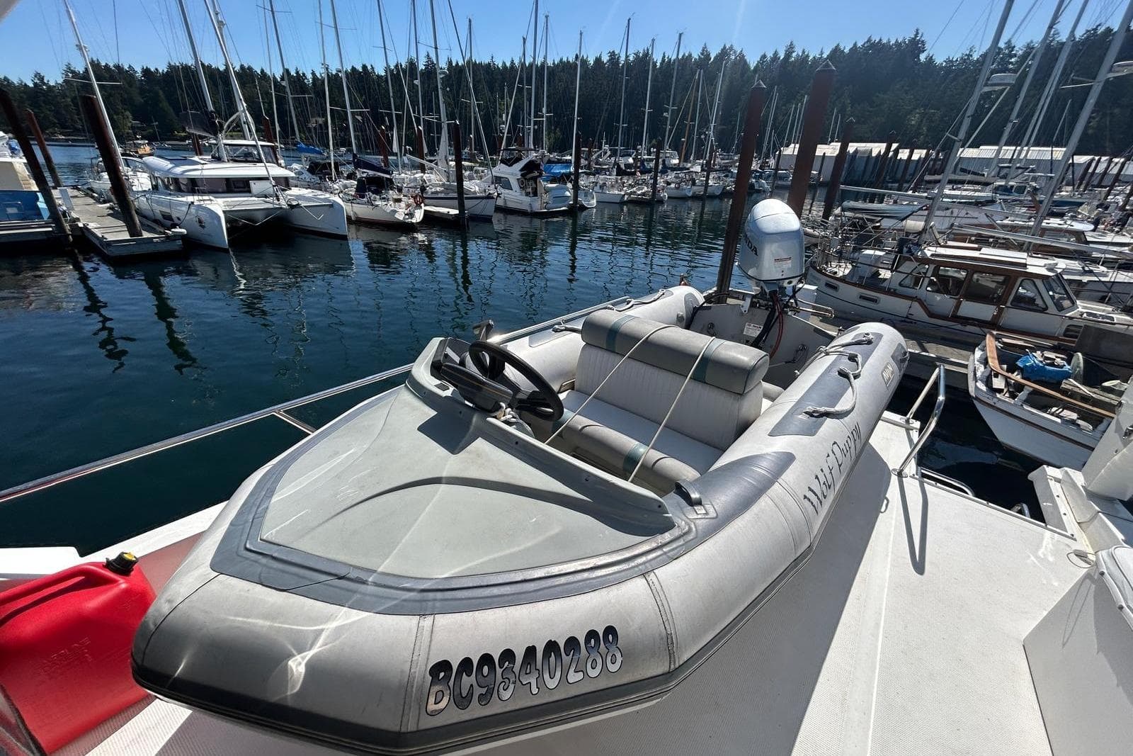 Inflatable boat docked on Ocean Alexander 520 Pilothouse, 1994 model, in a marina setting.