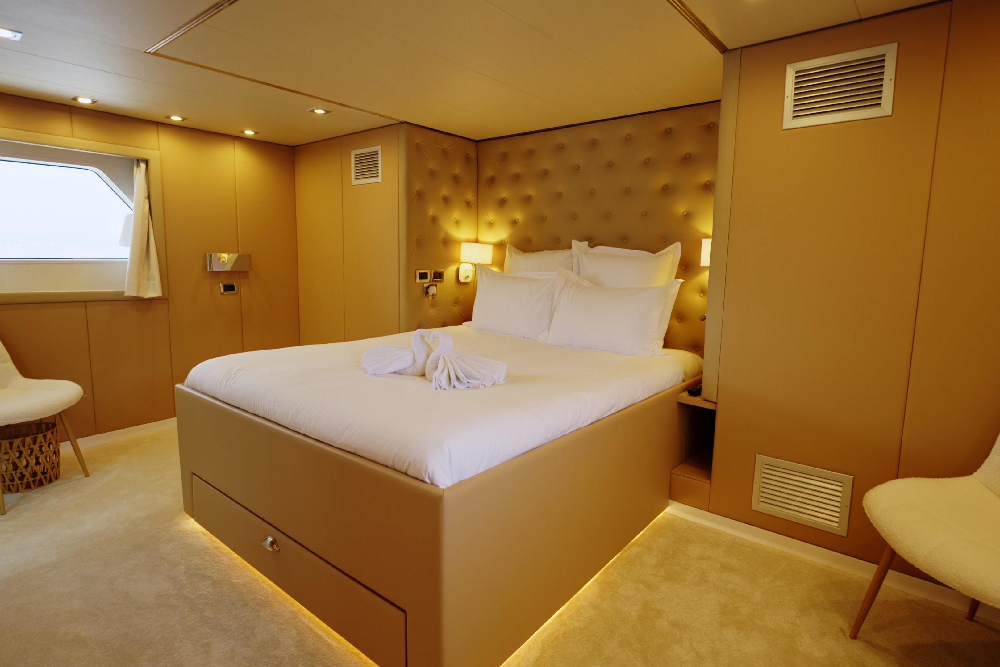 Luxurious bedroom interior on 1993 Cheoy Lee Custom yacht, featuring elegant design and ambient lighting.