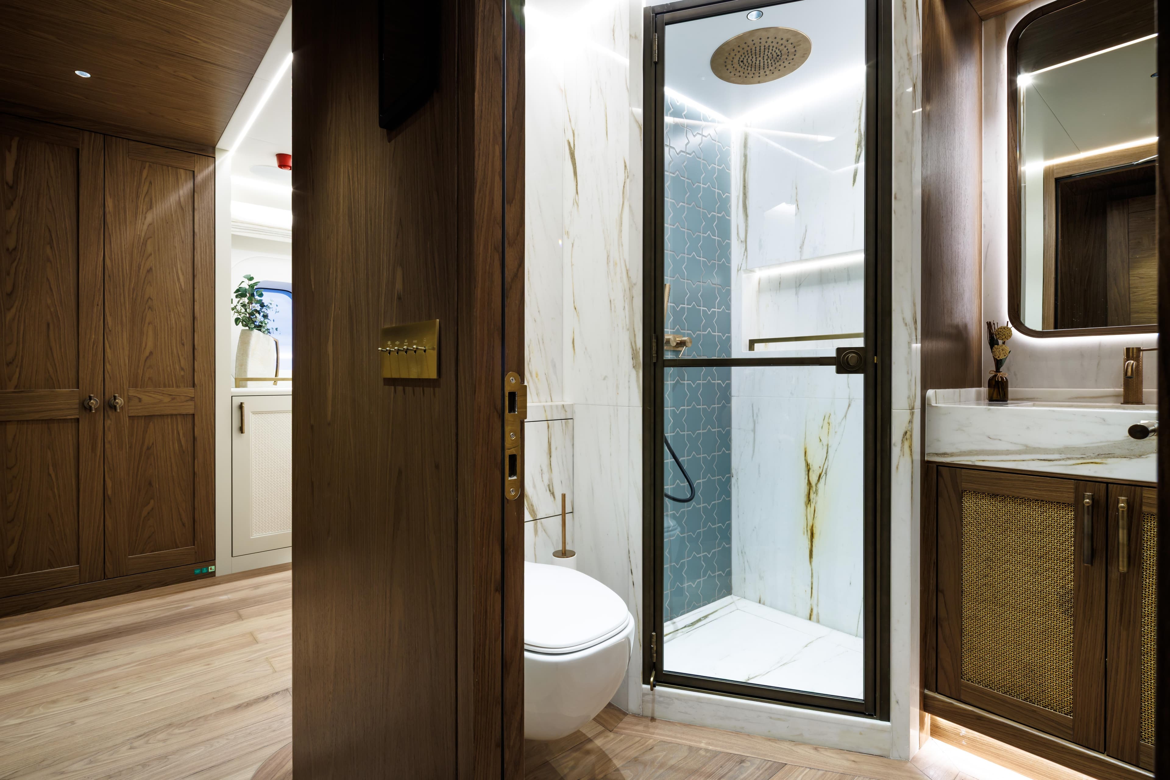 Luxurious bathroom interior in 2026 Custom Ares 62, featuring wood accents and modern fixtures.