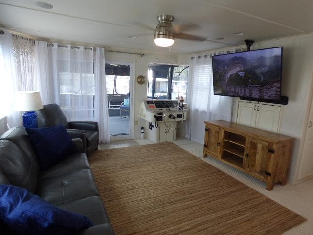 Spacious living area in a 2003 Sunstar 16x65 houseboat with modern amenities.