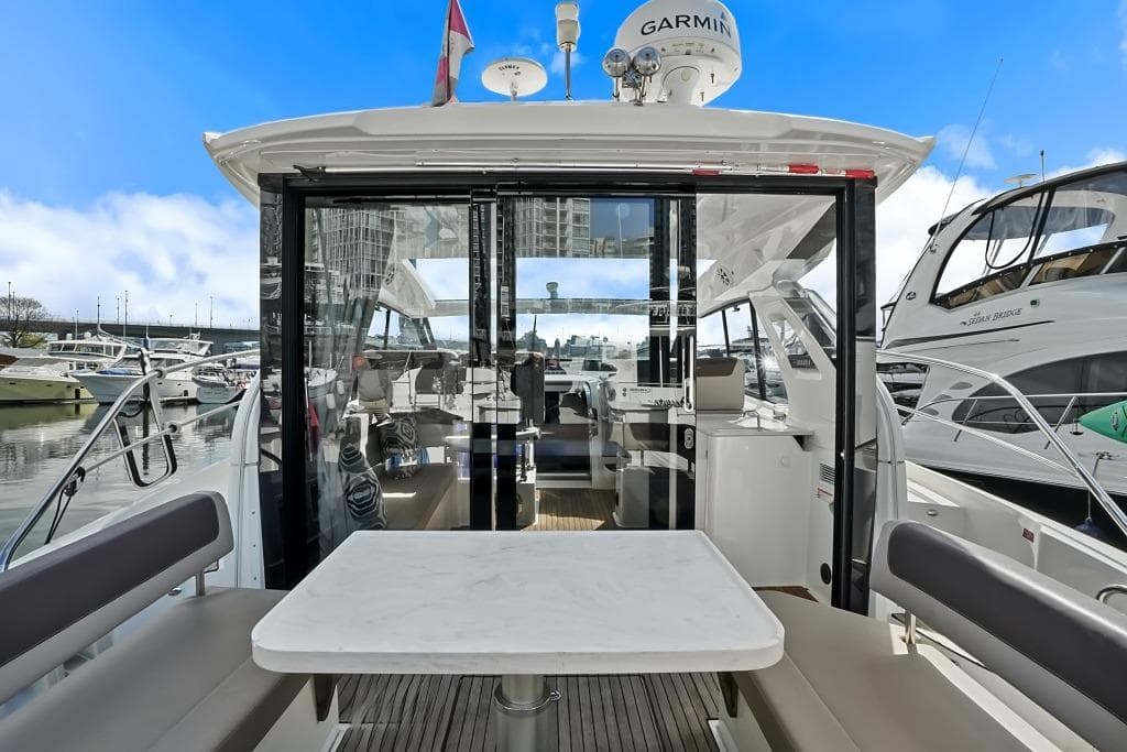2017 Bavaria S40 Coupe yacht interior with seating and table, docked at marina.