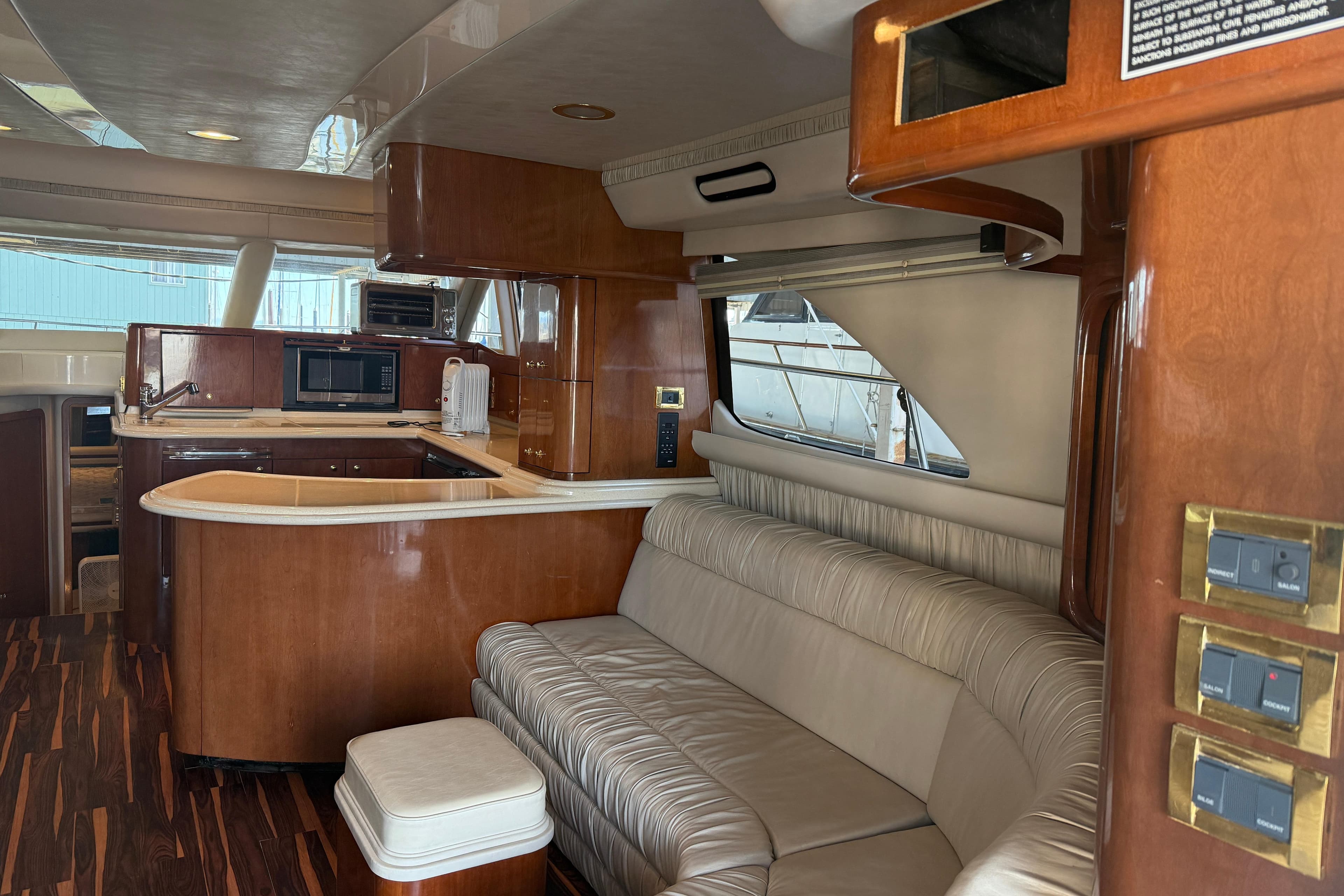 Luxurious interior of a 1999 Sea Ray 560 Sedan Bridge yacht with elegant wood finishes.