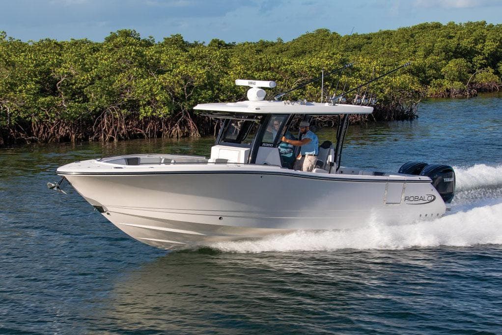 Manufacturer Provided Image: 2025 Robalo R300 Center Console boat cruising on water near lush mangroves.
