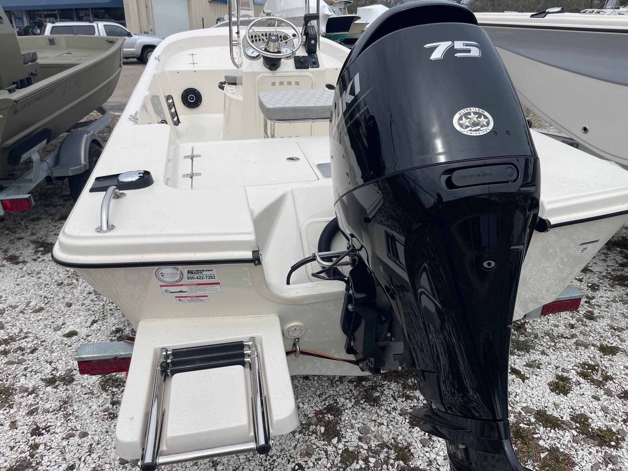 2025 Carolina Skiff 162 JLS boat with 75 HP outboard motor, rear view.