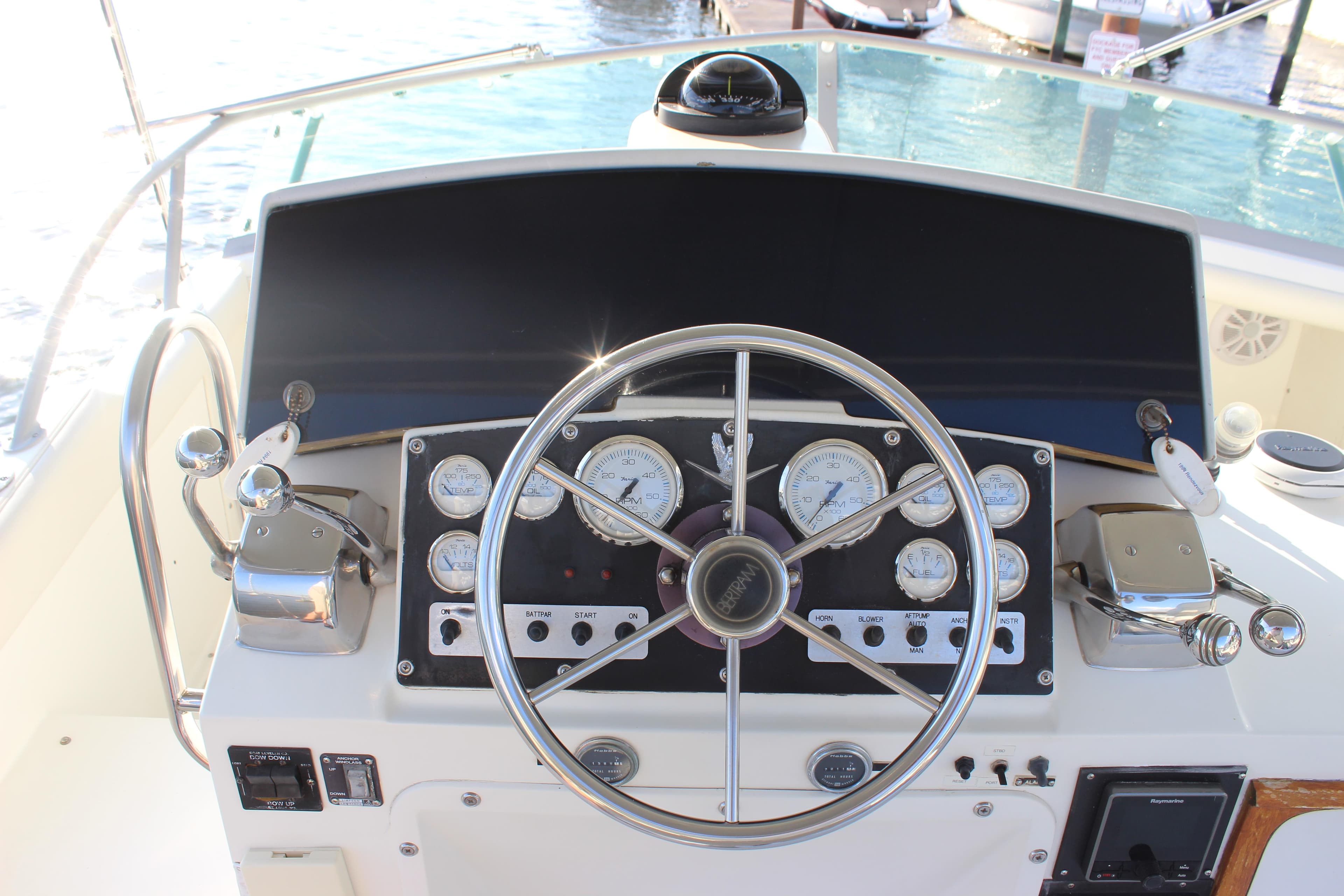 1988 Bertram 33II Flybridge Cruiser helm with steering wheel and instrument panel.