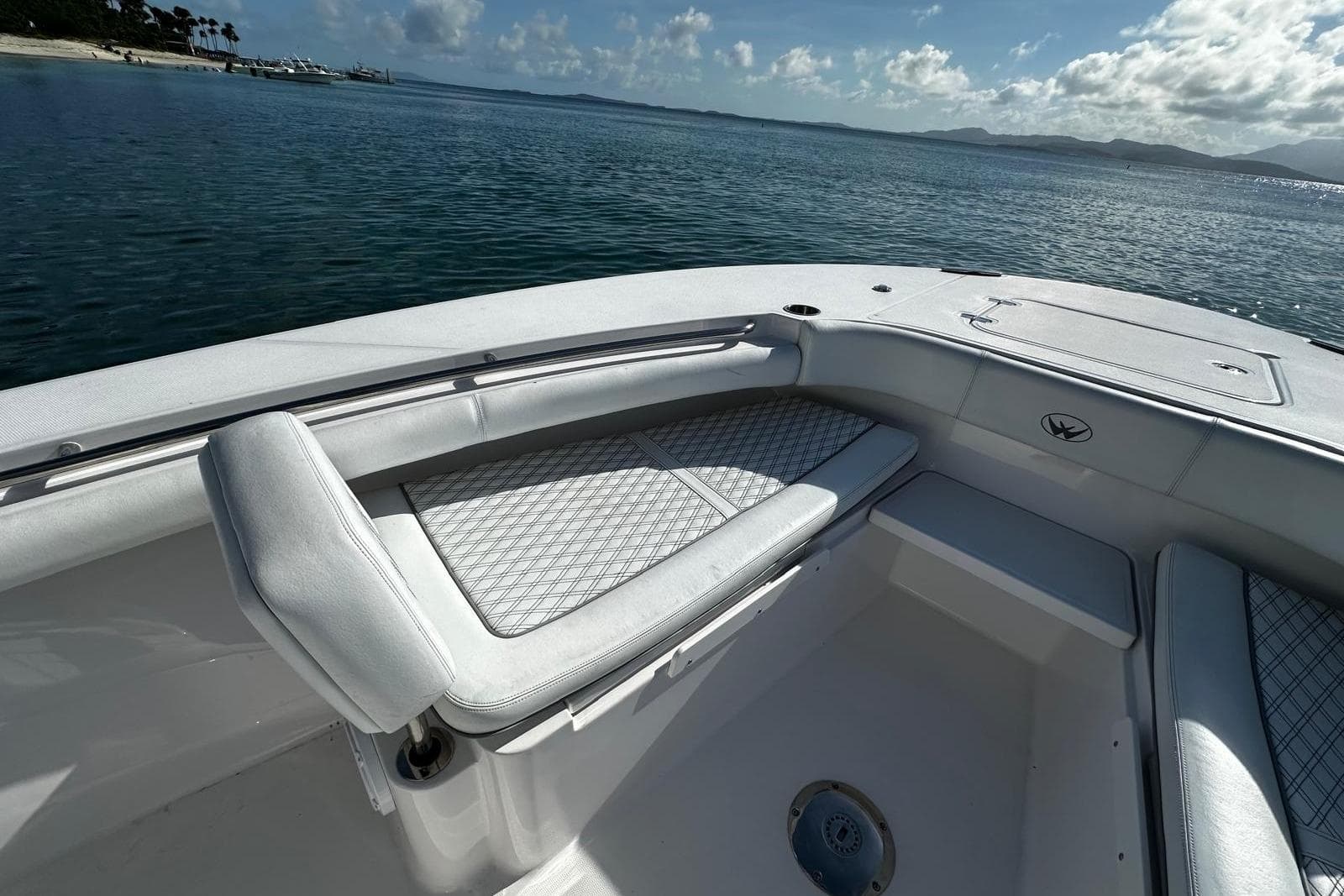 2024 Southport 30 FE boat interior with cushioned seating, overlooking calm waters.