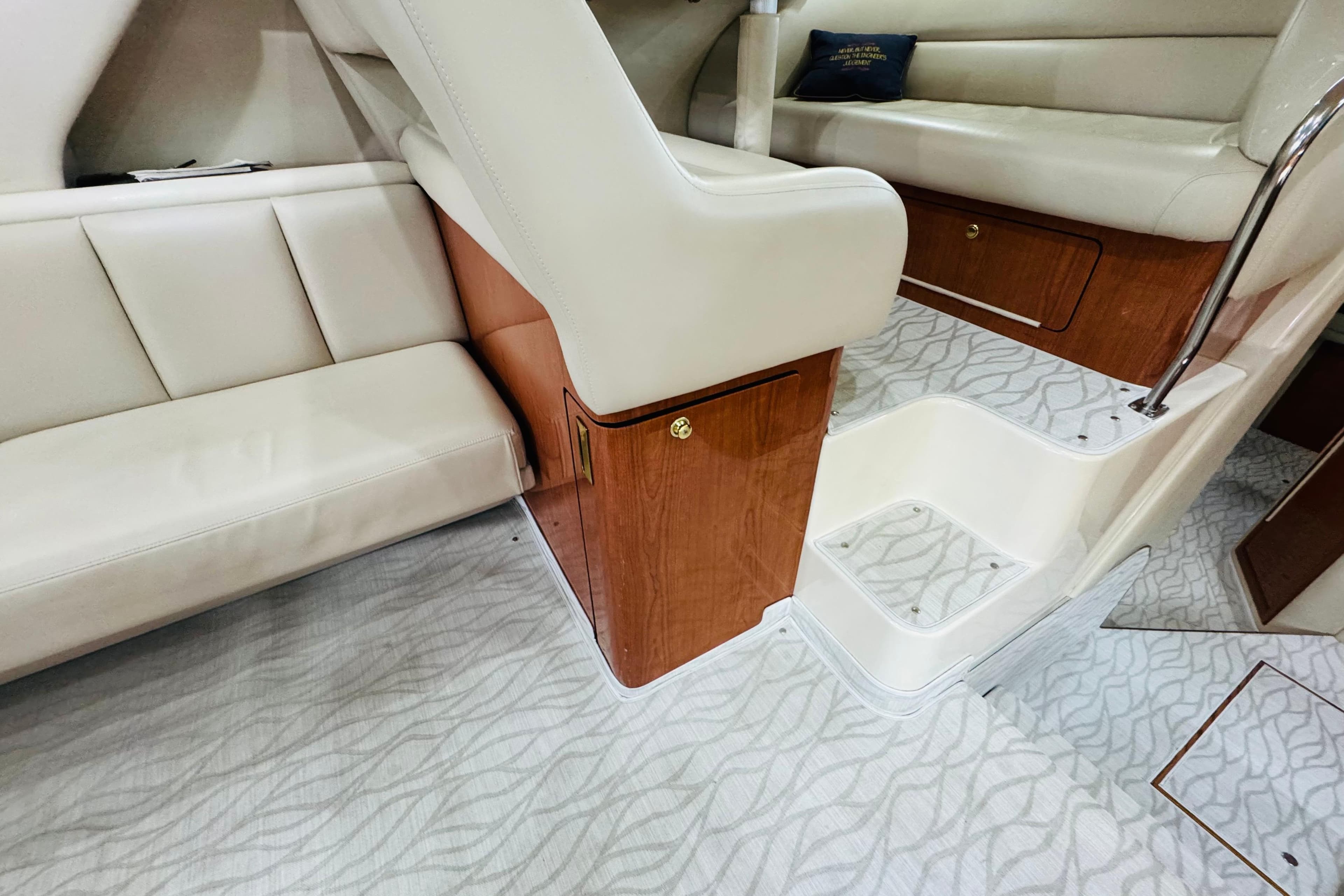Interior of 1999 Sea Ray 400 Sedan Bridge with beige seating and wood accents.