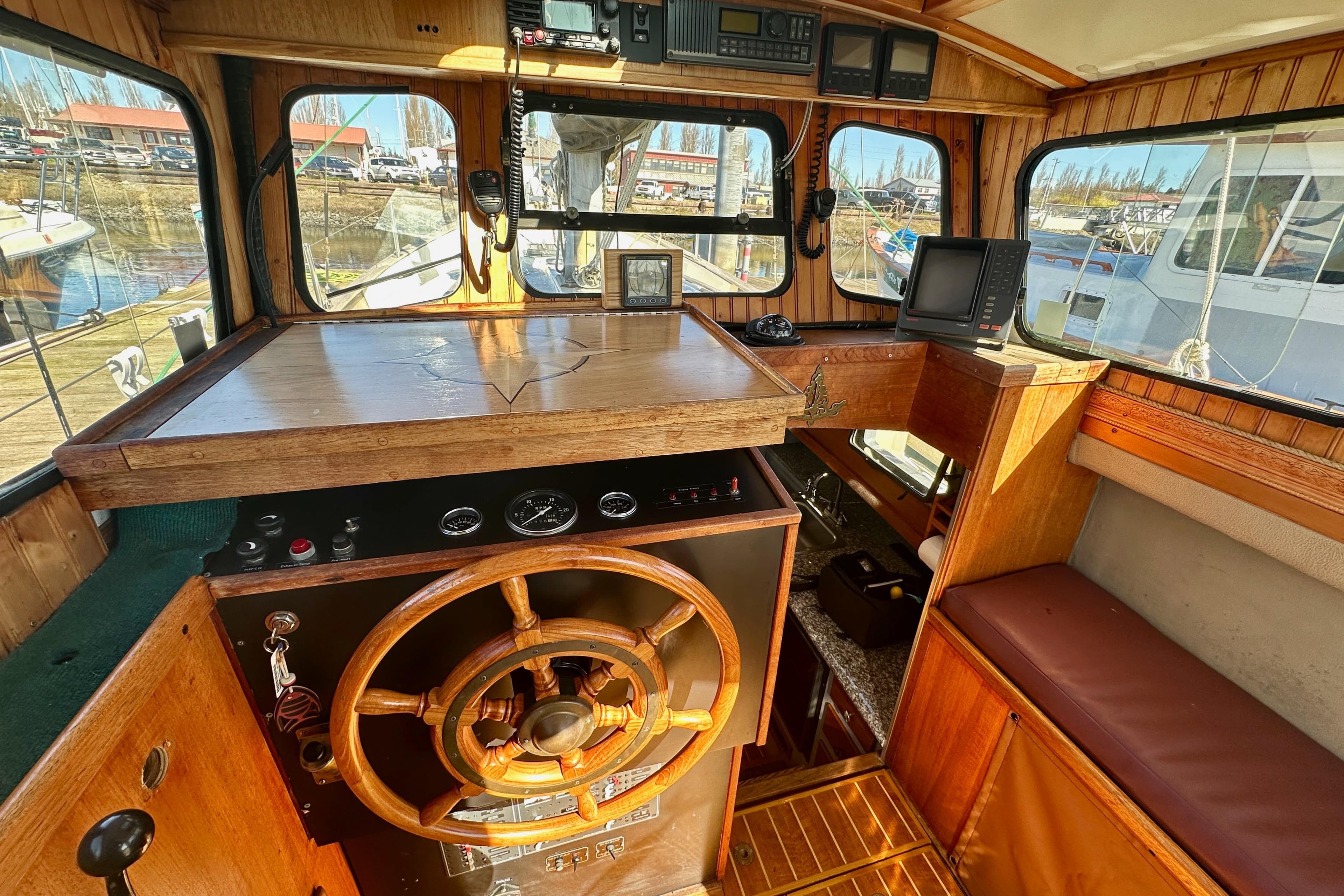 Interior of a 1972 Fisher 30 boat with wooden helm and navigation equipment.