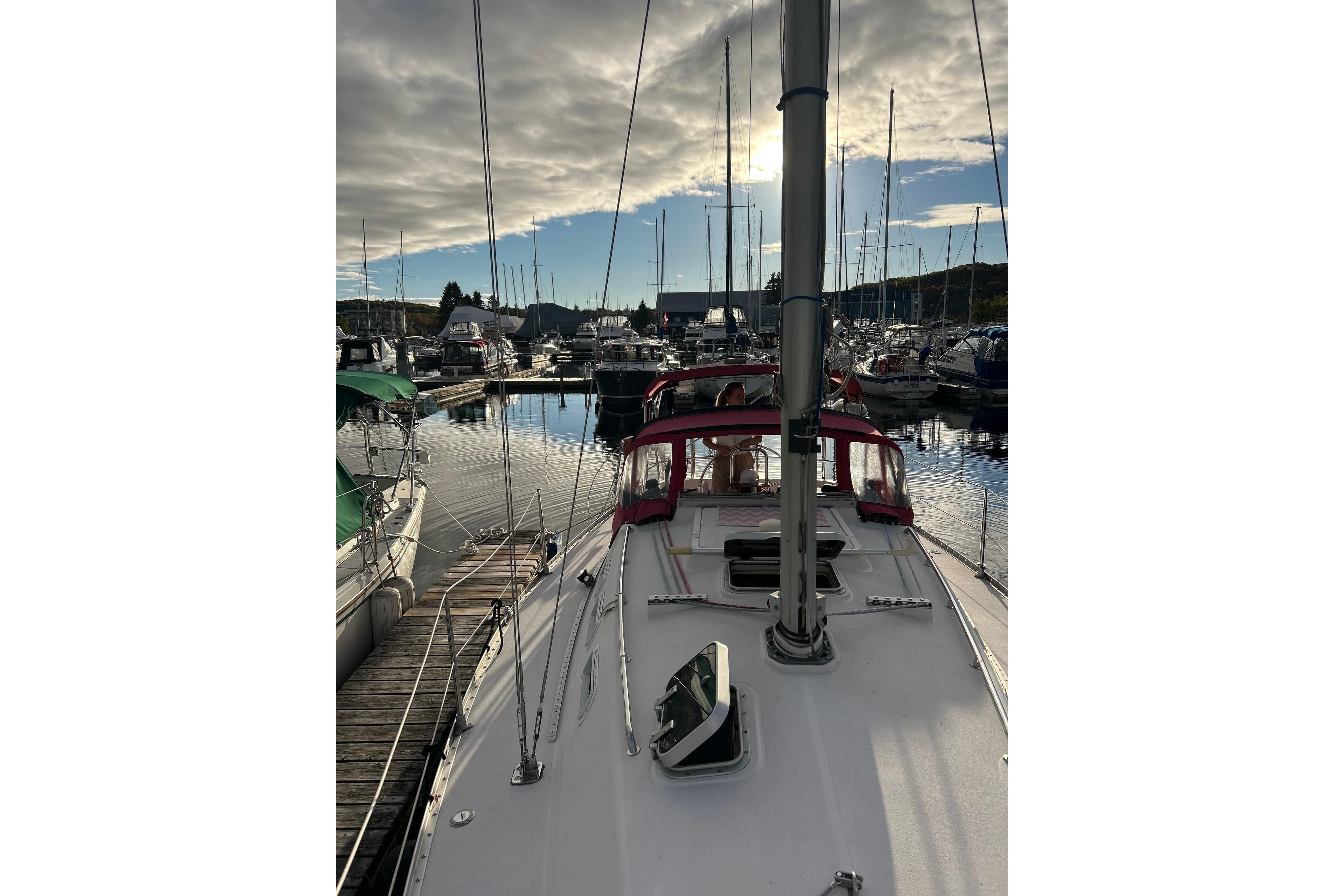 1985 CS 30 sailboat docked in a marina under a cloudy sky.