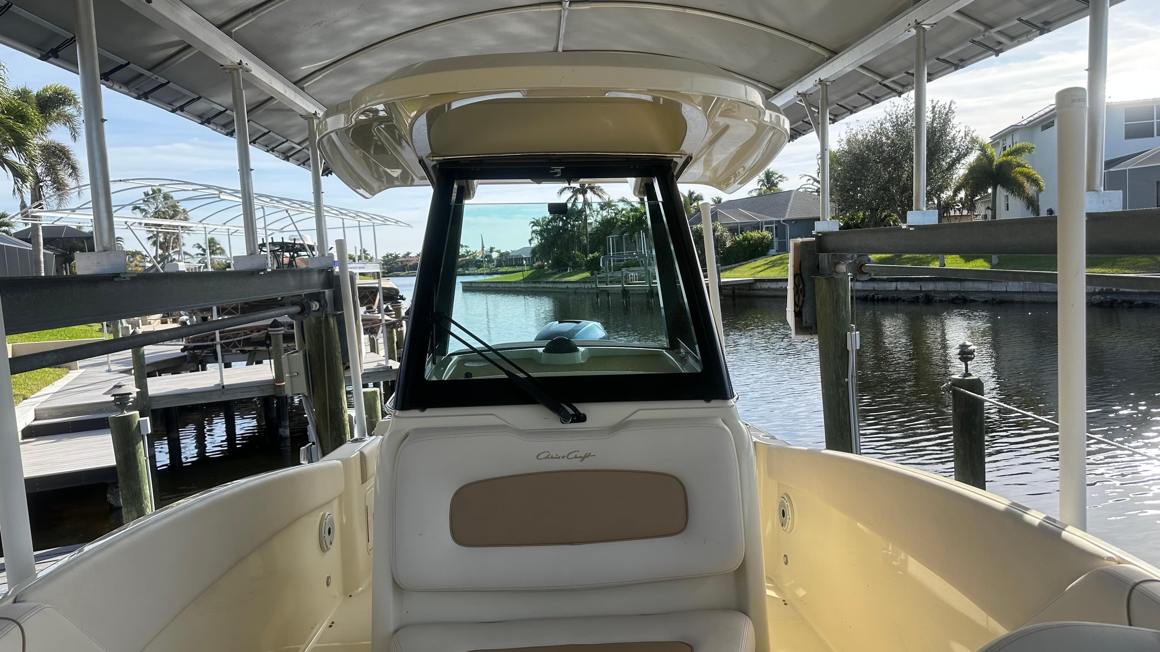 2023 Chris-Craft Catalina 24 boat docked by a scenic canal.