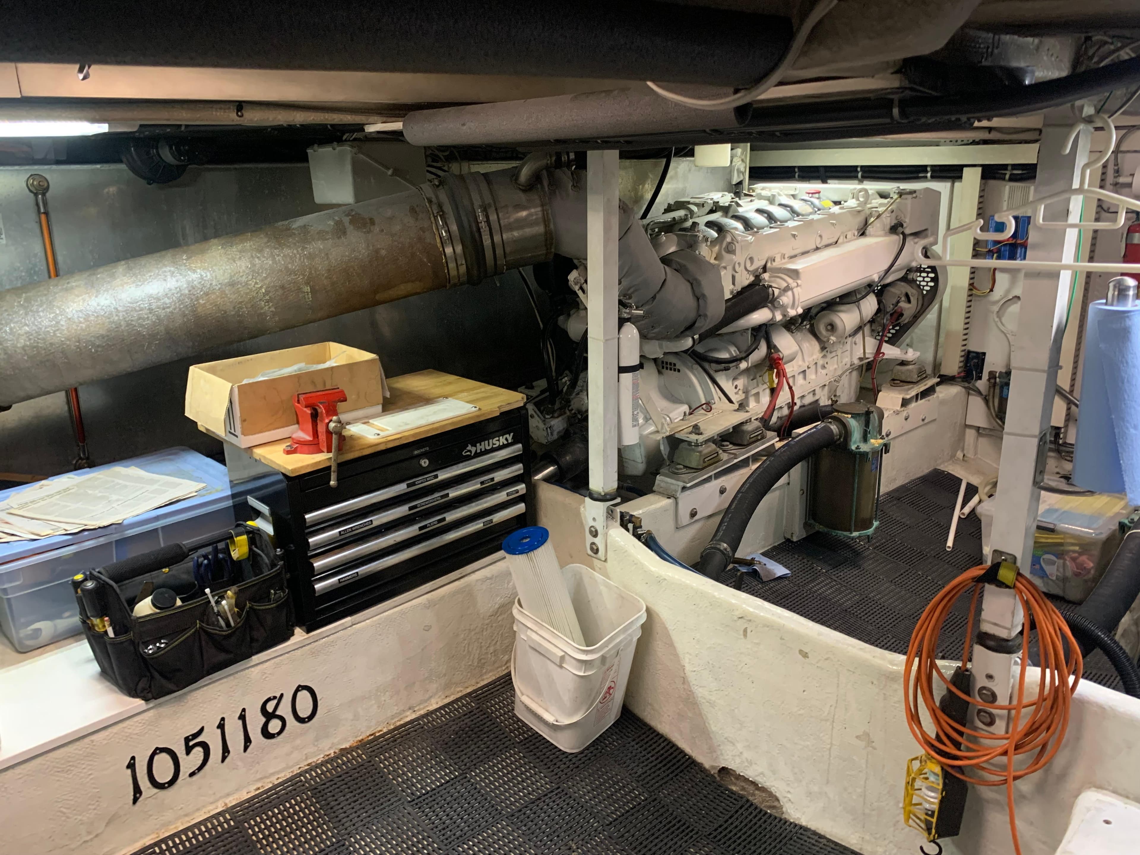 Engine room of a 1997 Bayliner Pilothouse with tools and equipment.
