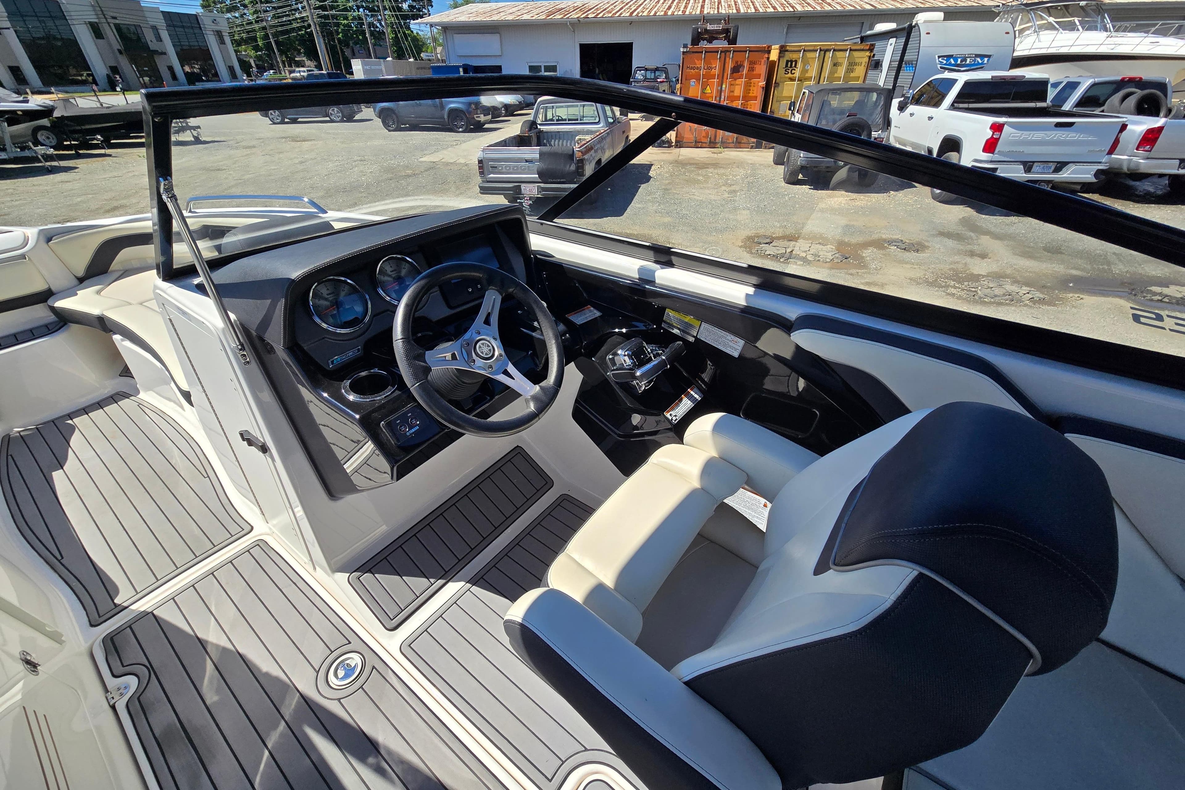 Interior of 2016 Yamaha Boats 242 Limited S E-Series, featuring sleek dashboard and steering wheel.