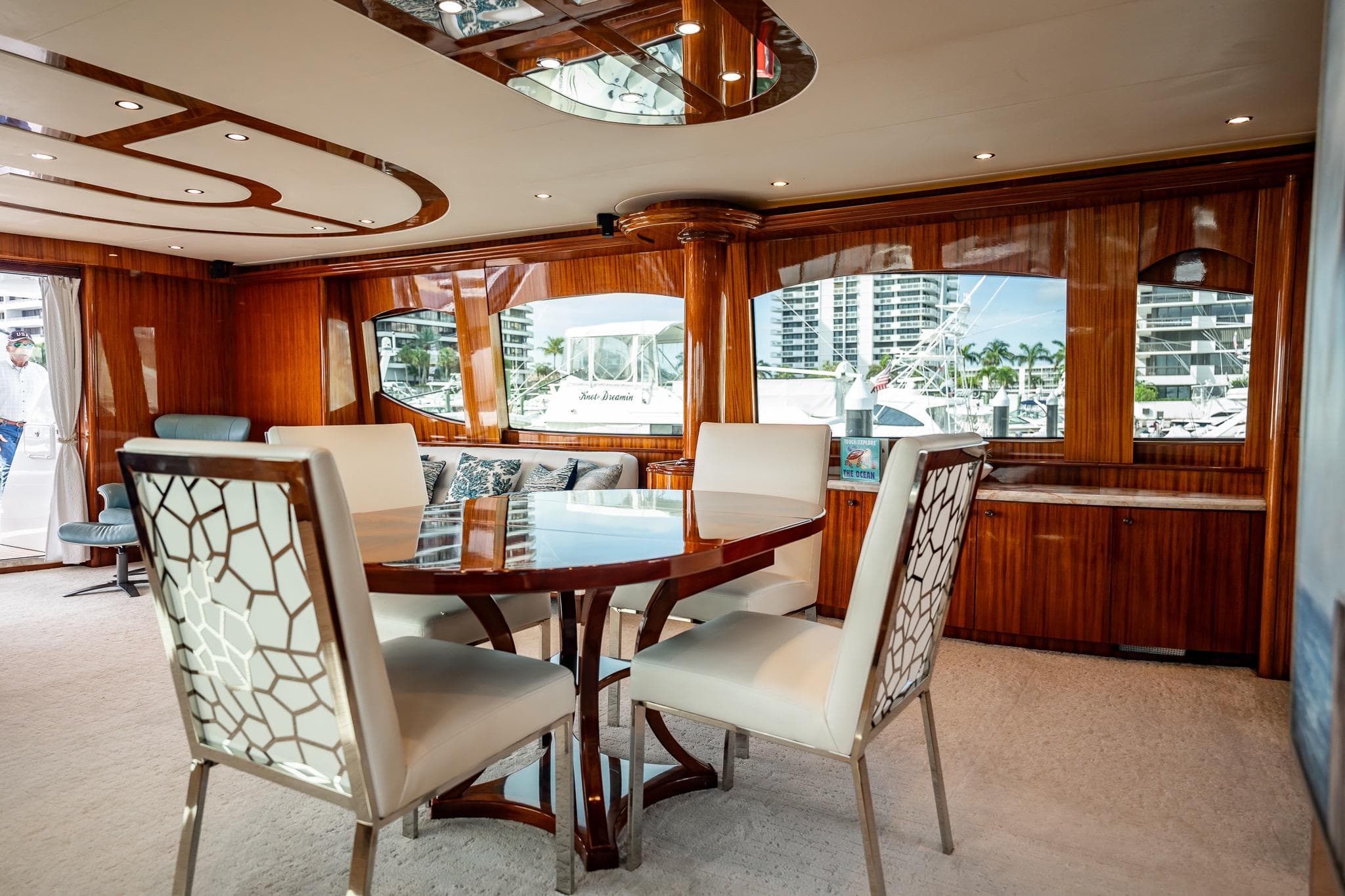 Luxurious interior of 2012 Hatteras 80 Motor Yacht with elegant dining area and panoramic windows.