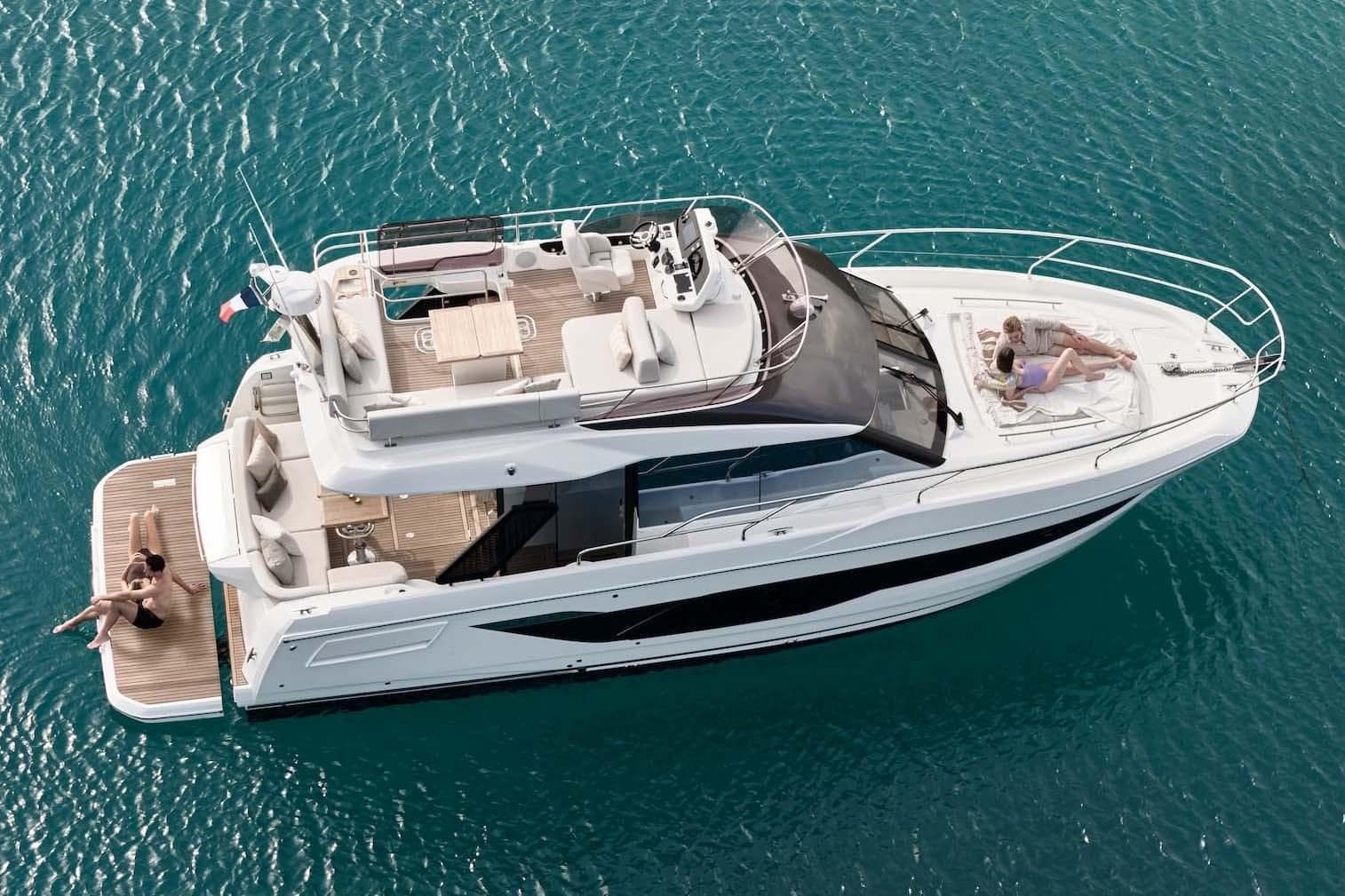 Manufacturer Provided Image: Luxury 2026 Prestige F4.3 yacht cruising on clear blue waters, with people relaxing onboard.
