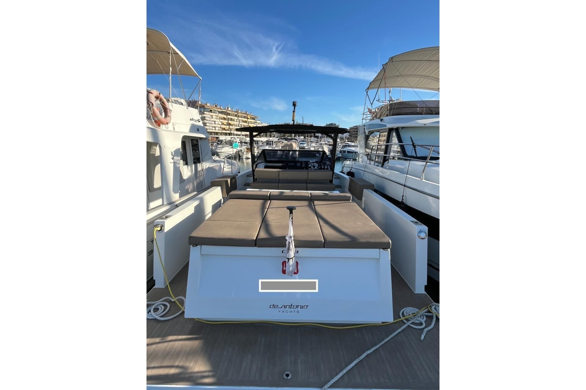 2018 De Antonio Yachts D33 docked, showcasing sleek design and spacious deck.