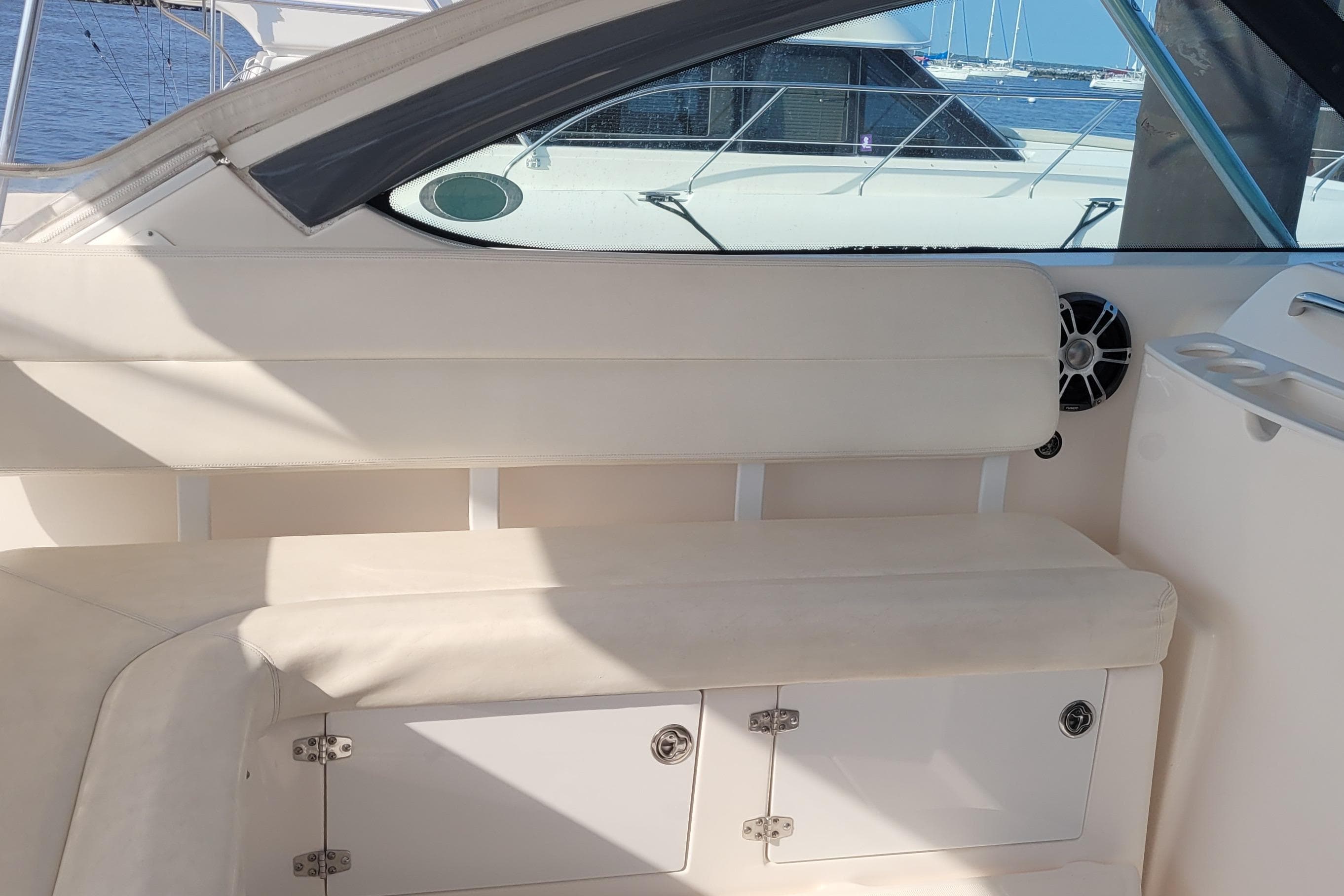 2006 Tiara Yachts 4200 Open interior seating with storage, docked by the water.