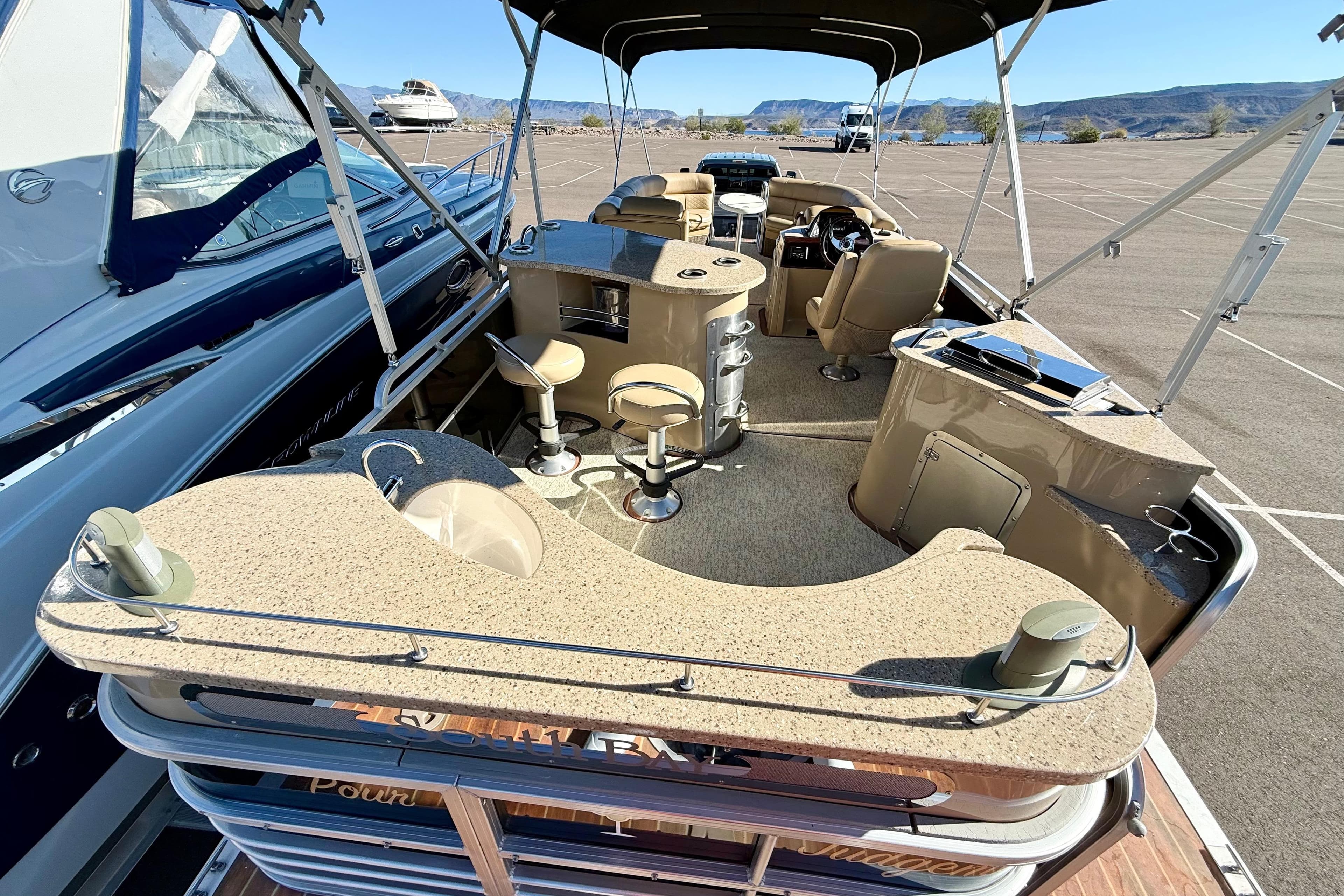 2014 South Bay 724 E DLX TT pontoon boat with spacious seating and modern amenities.