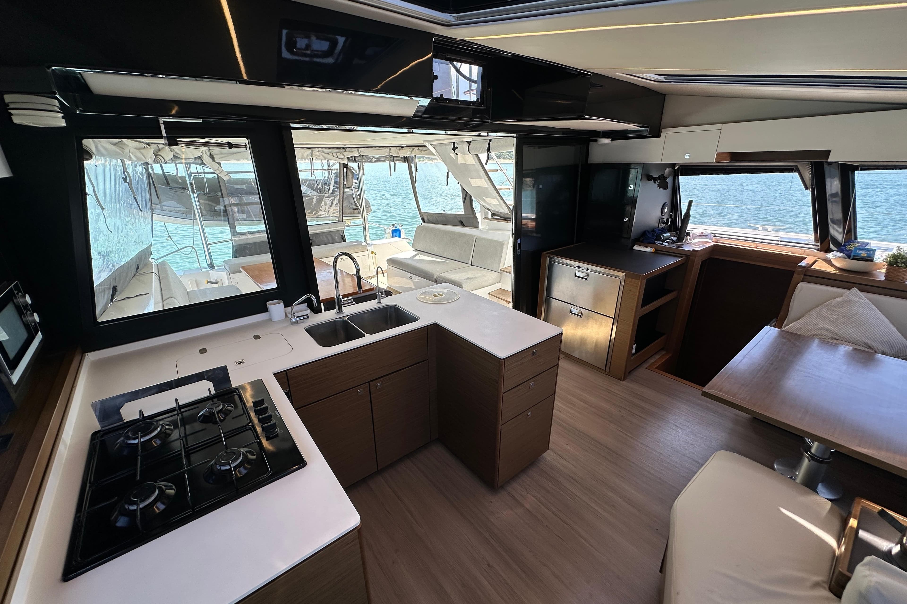 Luxurious interior of 2021 Nautitech 46 Fly catamaran with modern kitchen and seating area.