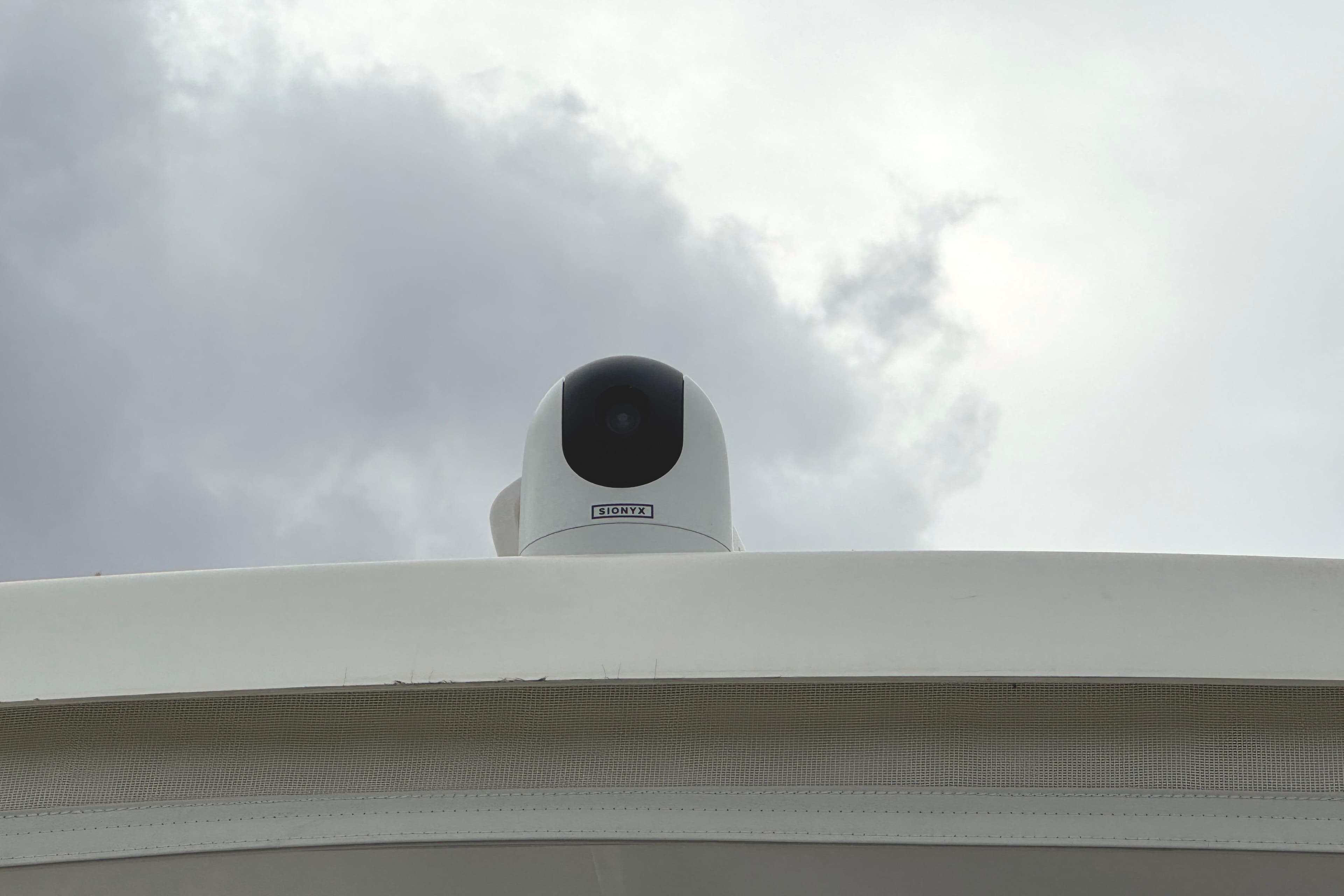 Camera mounted on 1991 Viking 53 Convertible yacht under cloudy sky.