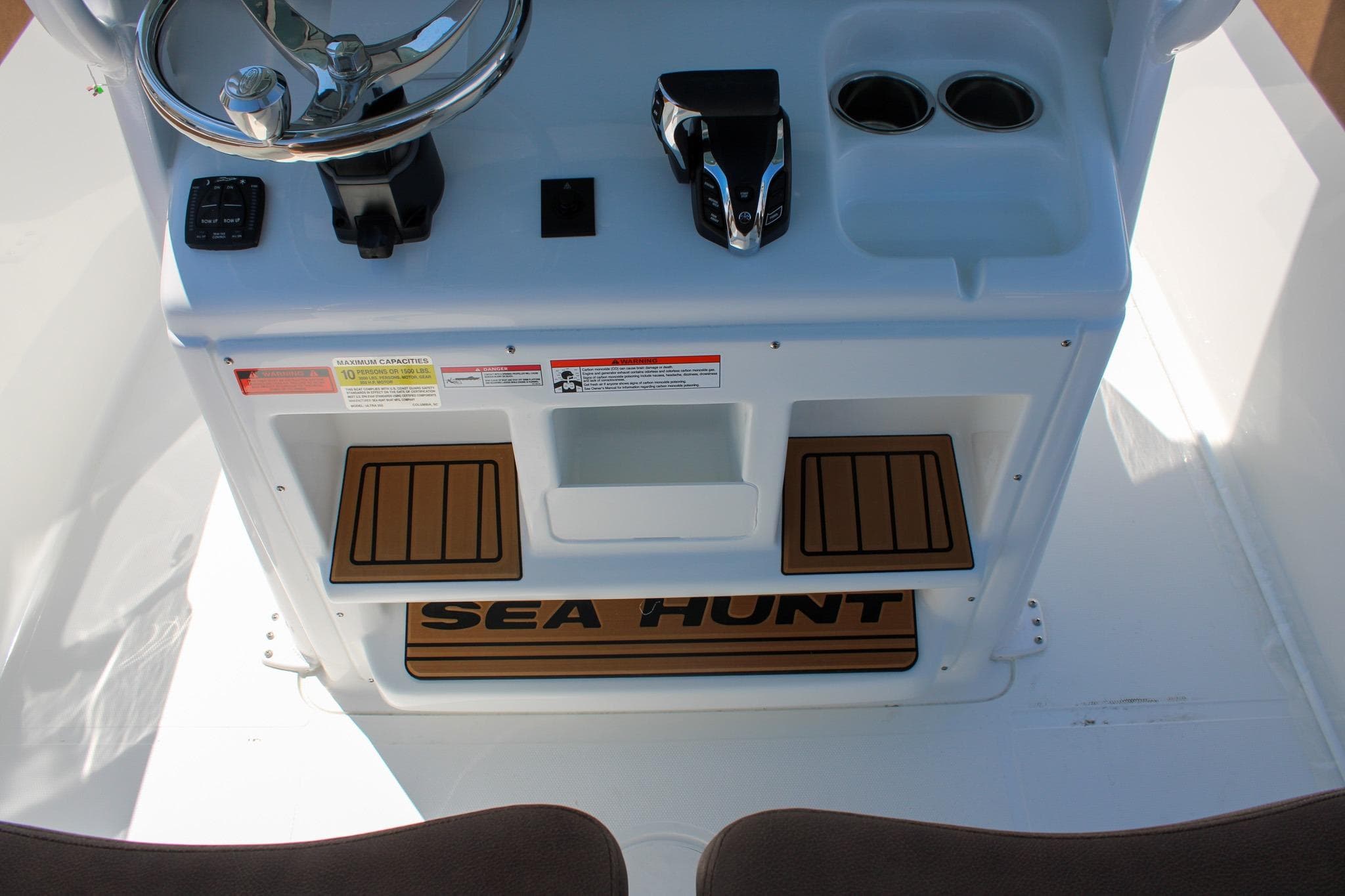 Center console of 2026 Sea Hunt Ultra 255 SE boat with steering wheel and controls.