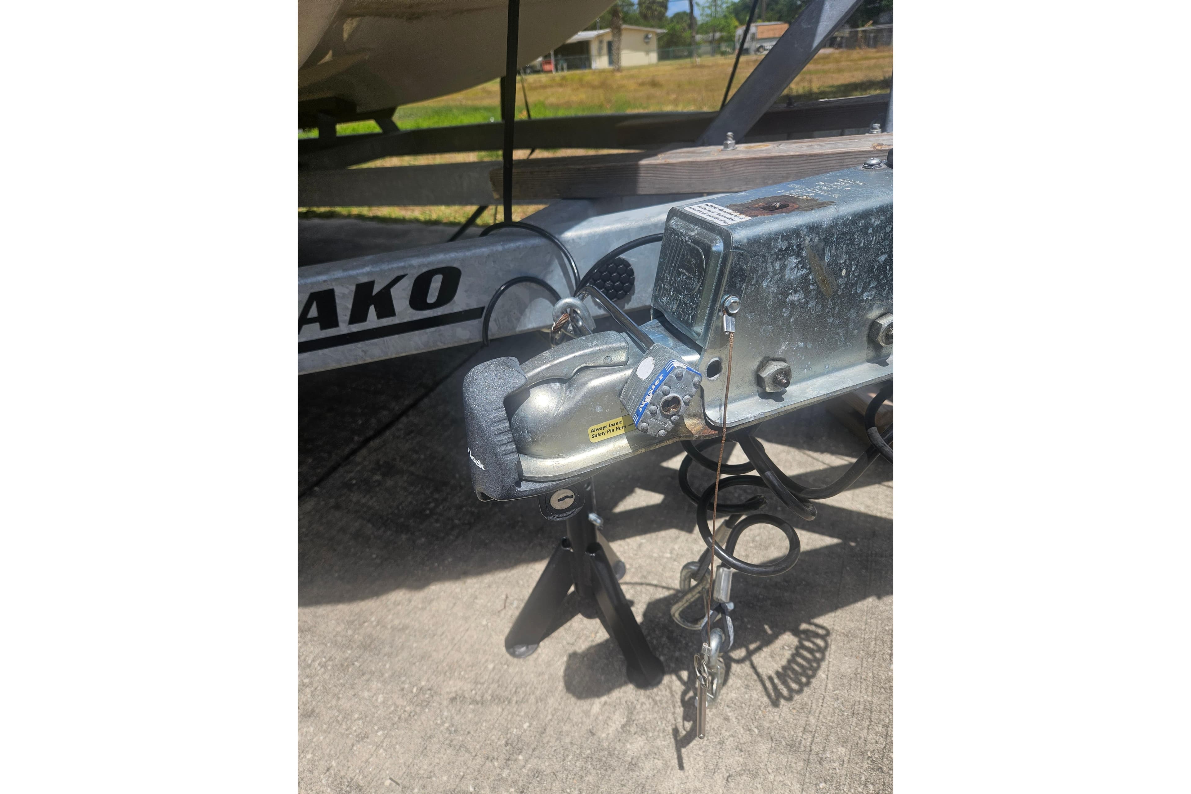 Trailer hitch of 2023 Mako Pro Skiff 19 CC boat on concrete surface.