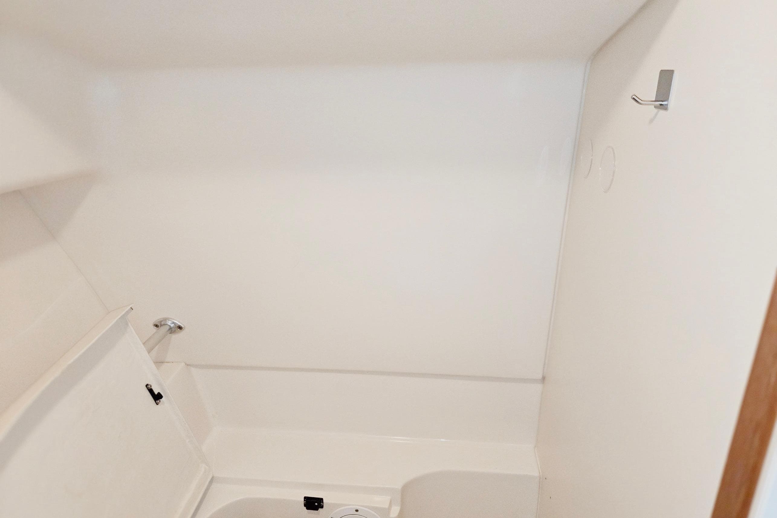 Interior of 1998 Mainship Pilot 30 boat, featuring a compact, white bathroom space.