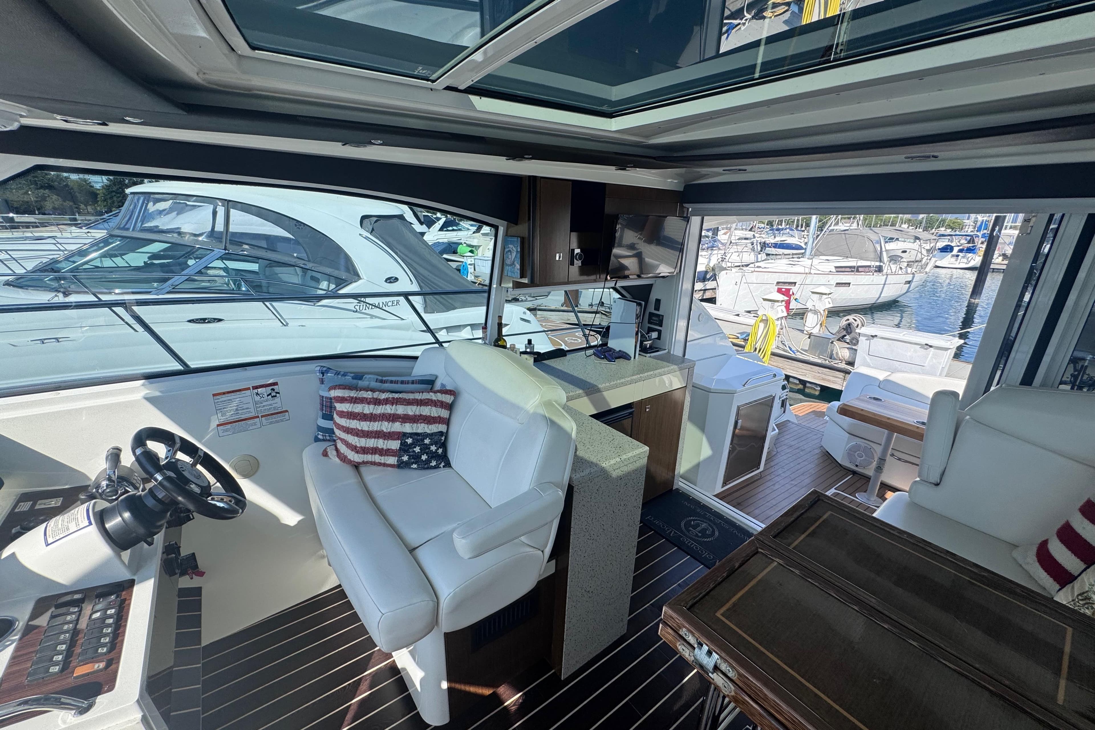 Interior of 2012 Cruisers Yachts 41 Cantius with white seating and marina view.