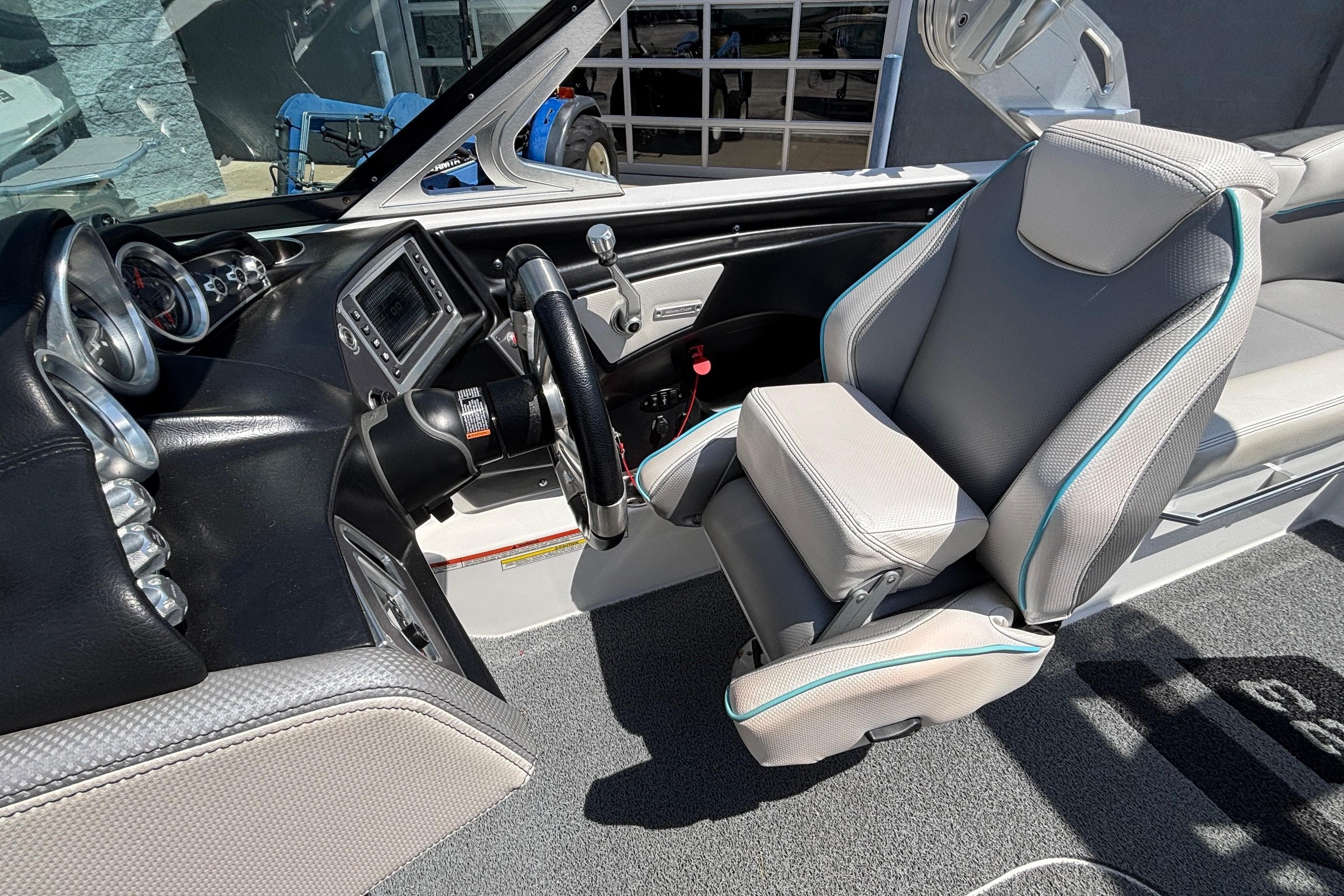 2017 MasterCraft XT23 boat interior with steering wheel and dashboard controls.