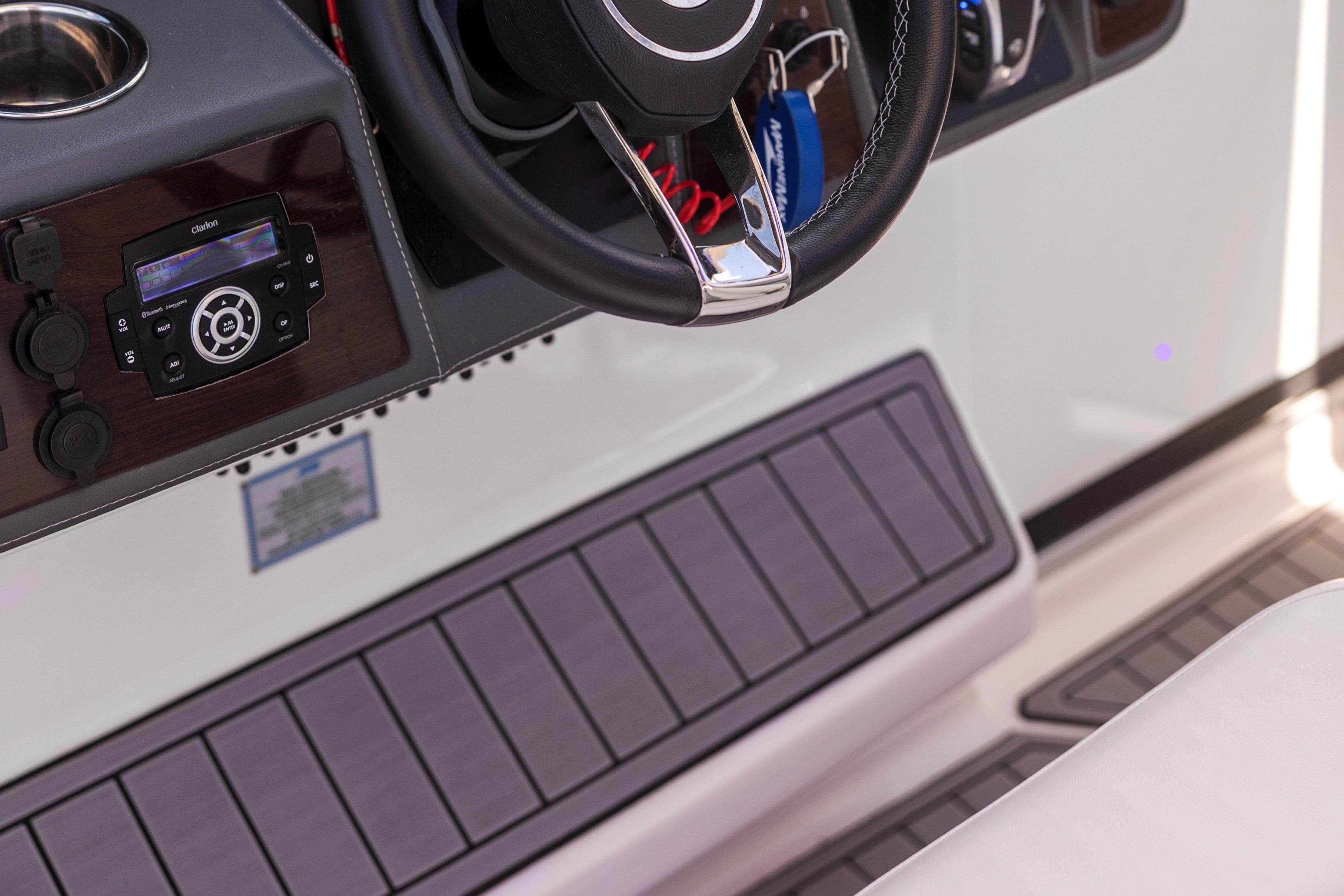 2022 Chaparral 300 OSX boat dashboard with steering wheel and control panel.