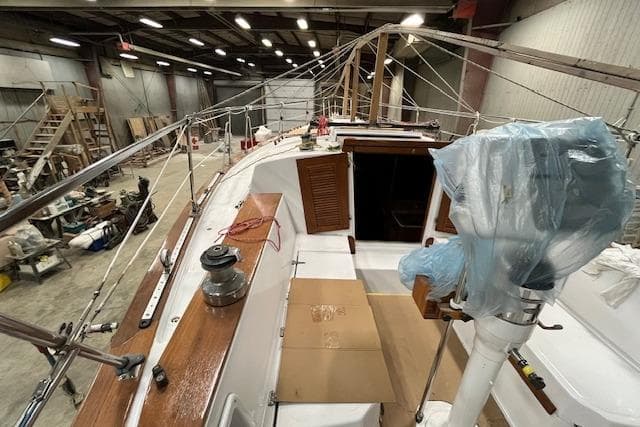 1983 Endeavour 35 sailboat undergoing maintenance in a spacious indoor facility.