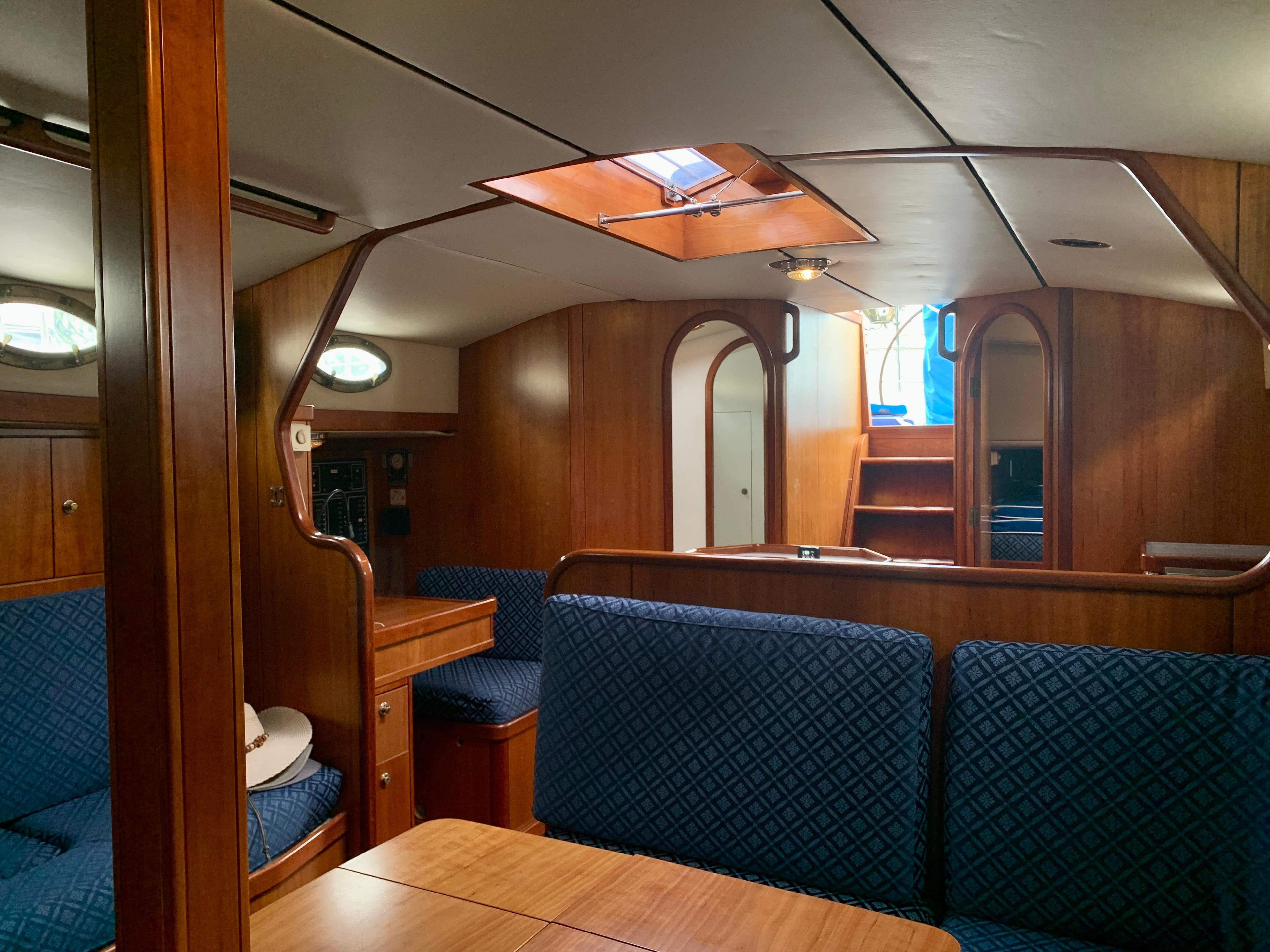 Luxurious interior of 2004 ShearWater 45 yacht with wooden finish and blue seating.