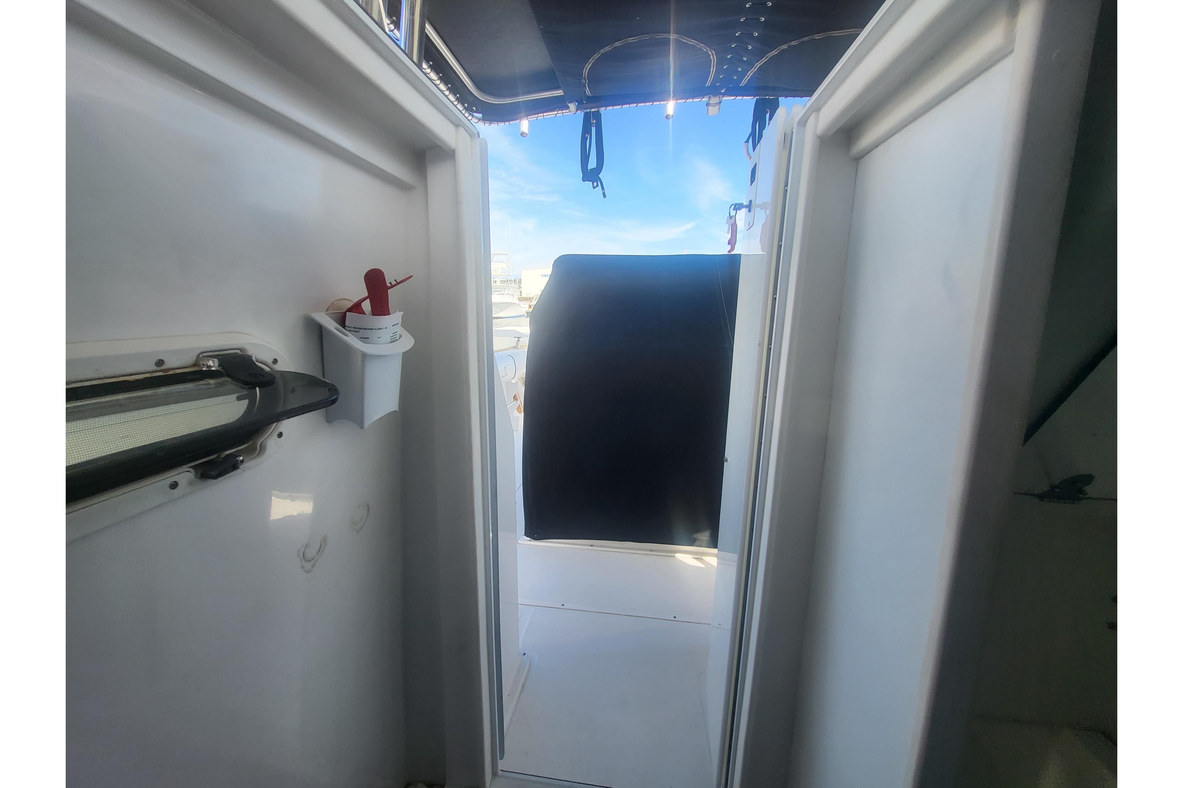 Interior view of 2005 Stamas 310 Tarpon boat, showing doorway and deck area.