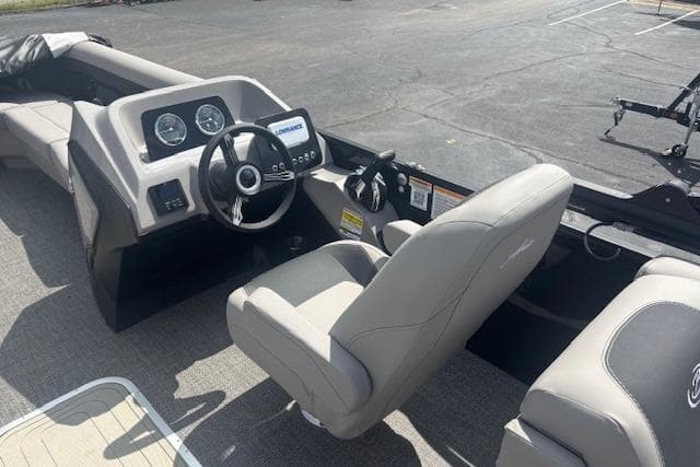 Interior view of 2026 Barletta A24QC boat, featuring modern dashboard and comfortable seating.