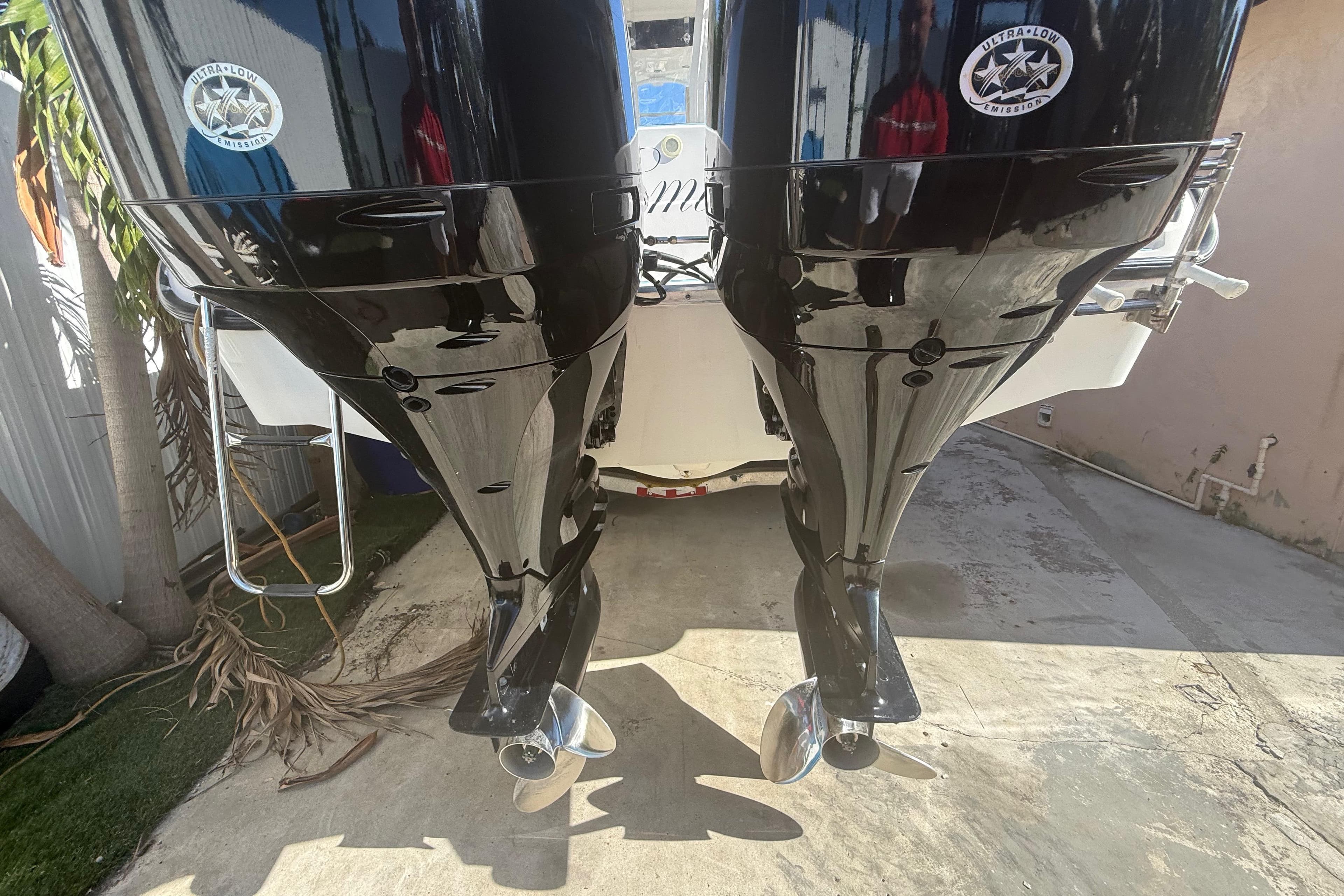 Twin outboard motors on a 1996 Grady-White Sailfish 272 boat, showcasing ultra-low emission technology.