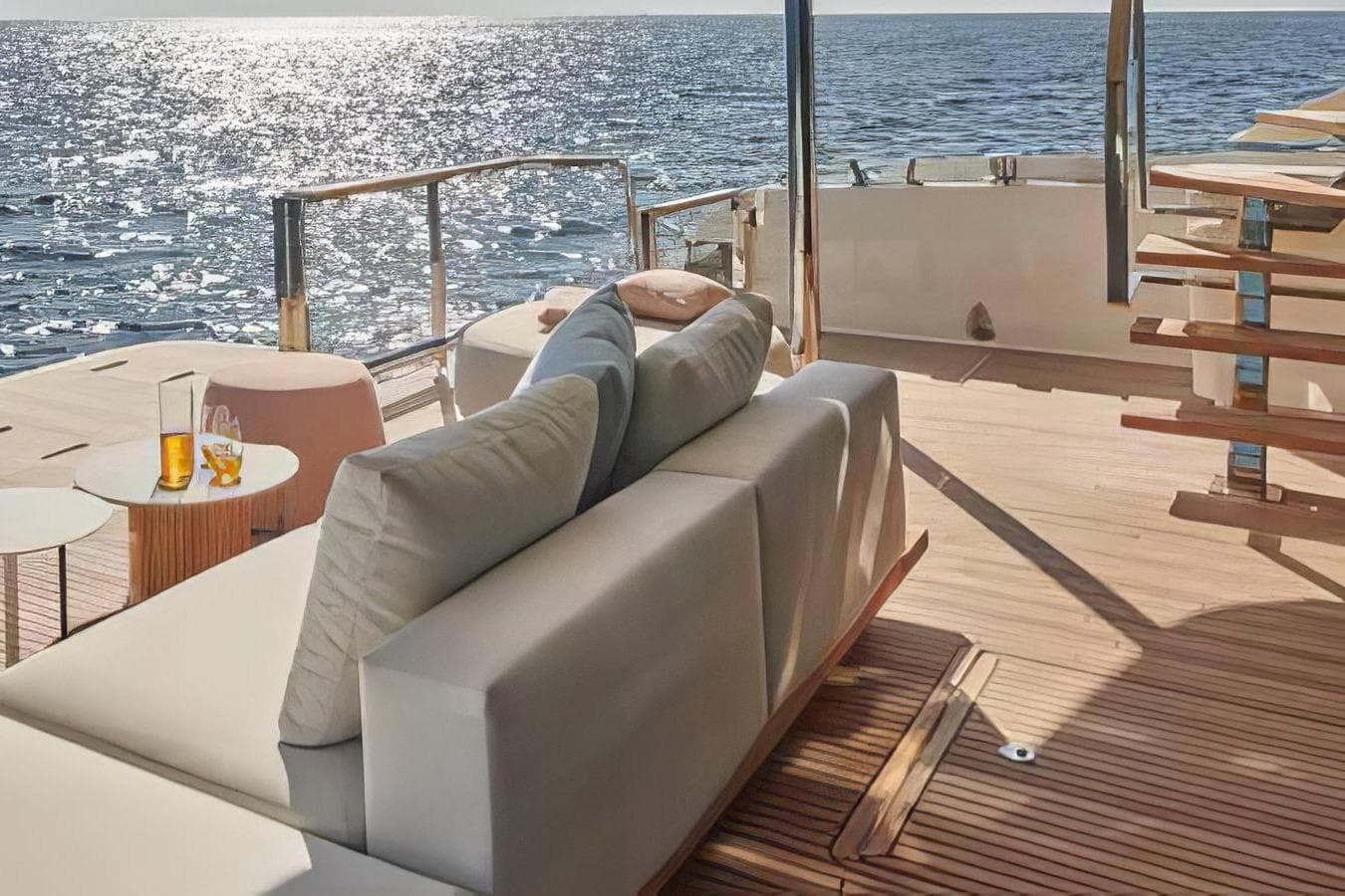 Luxurious 2026 Prestige yacht deck with elegant seating, ocean view, and sunlight reflections.