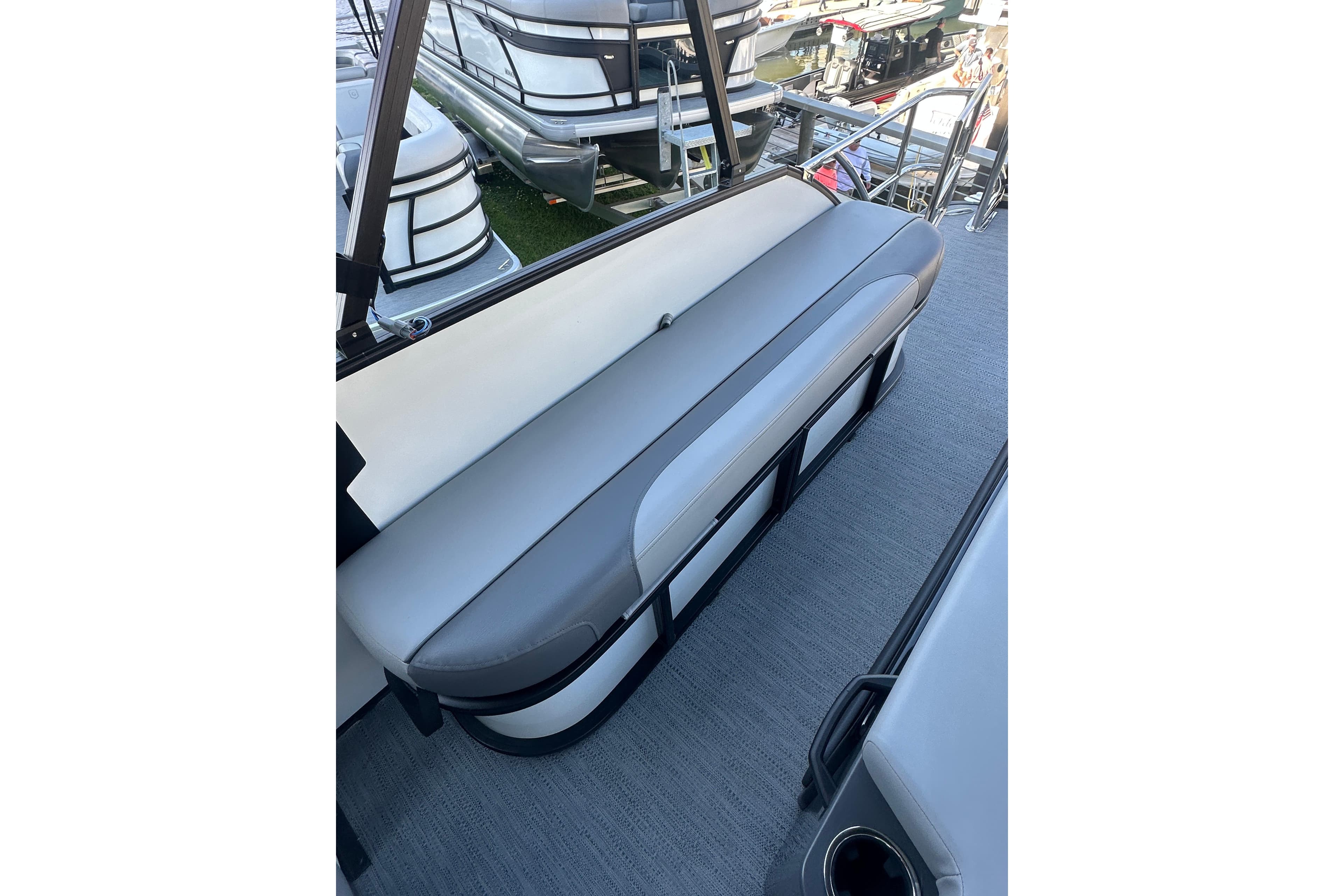 2026 Godfrey Monaco 235 SFL boat interior with sleek gray seating and modern design.