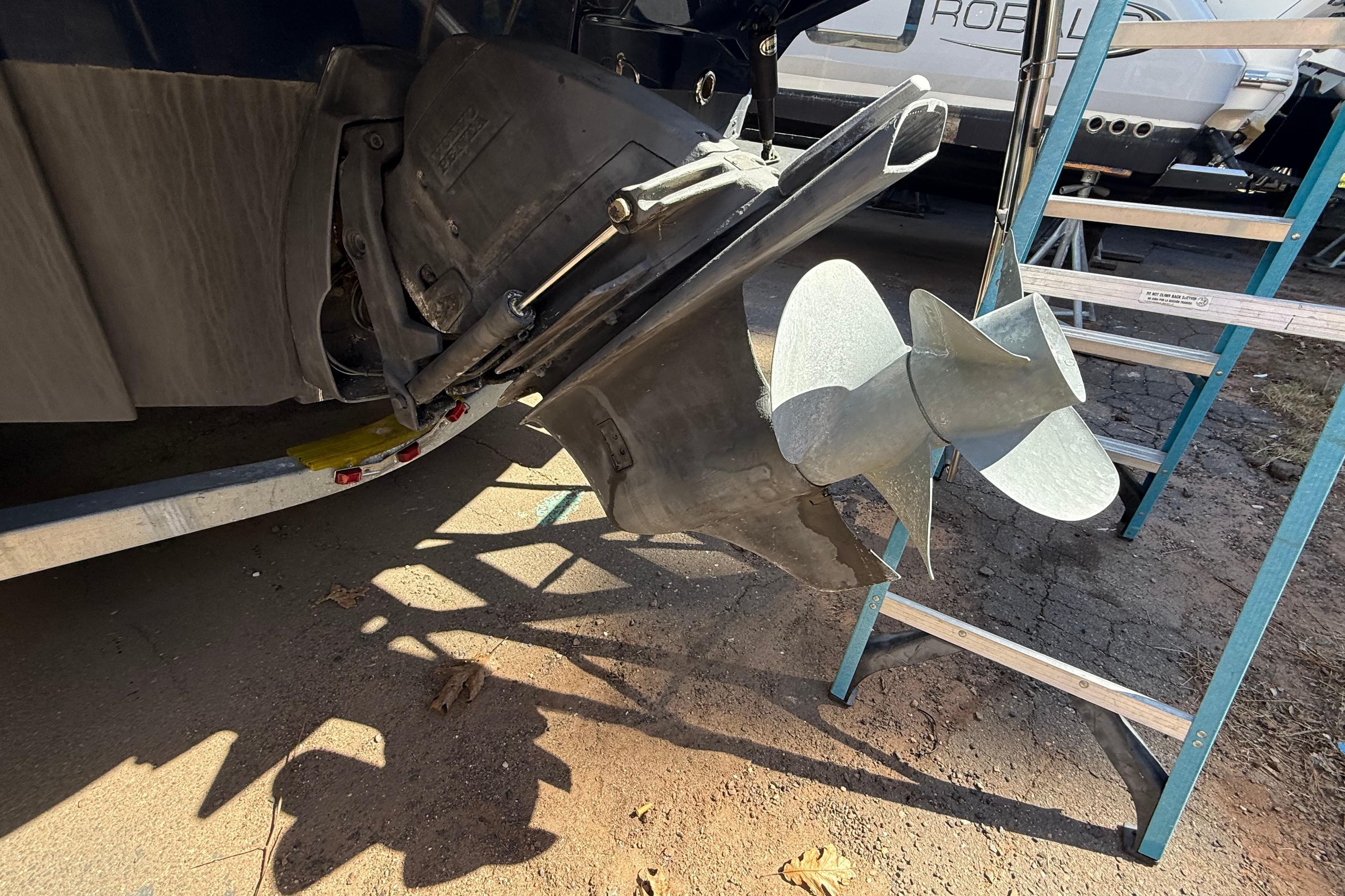 Close-up of a 2016 Cutwater 24 boat propeller and outdrive on a trailer.