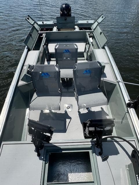 Custom Ultimate Panfish XL 2025 fishing boat with seating and equipment on a calm lake.