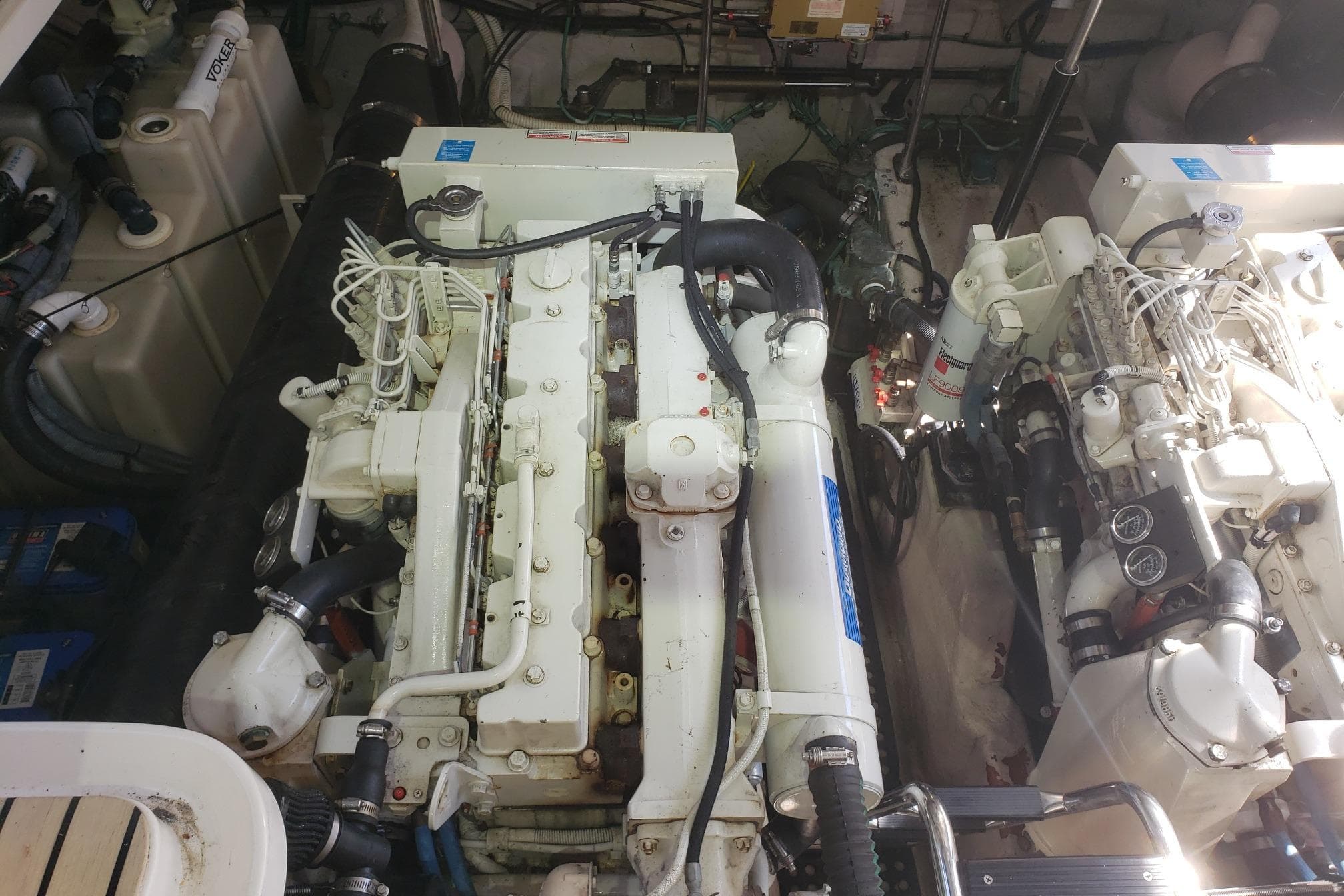 Engine room of a 2003 Sea Ray 420 Sundancer, showcasing dual marine engines.