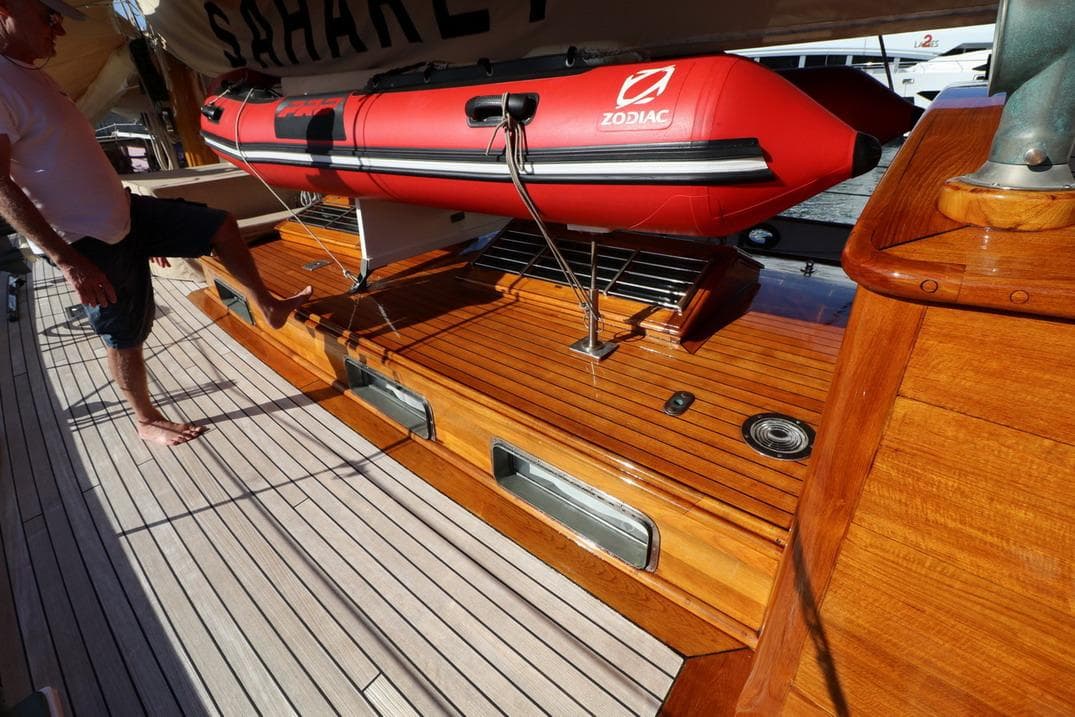 Classic 1933 Camper & Nicholsons wooden ketch deck with red Zodiac inflatable boat.