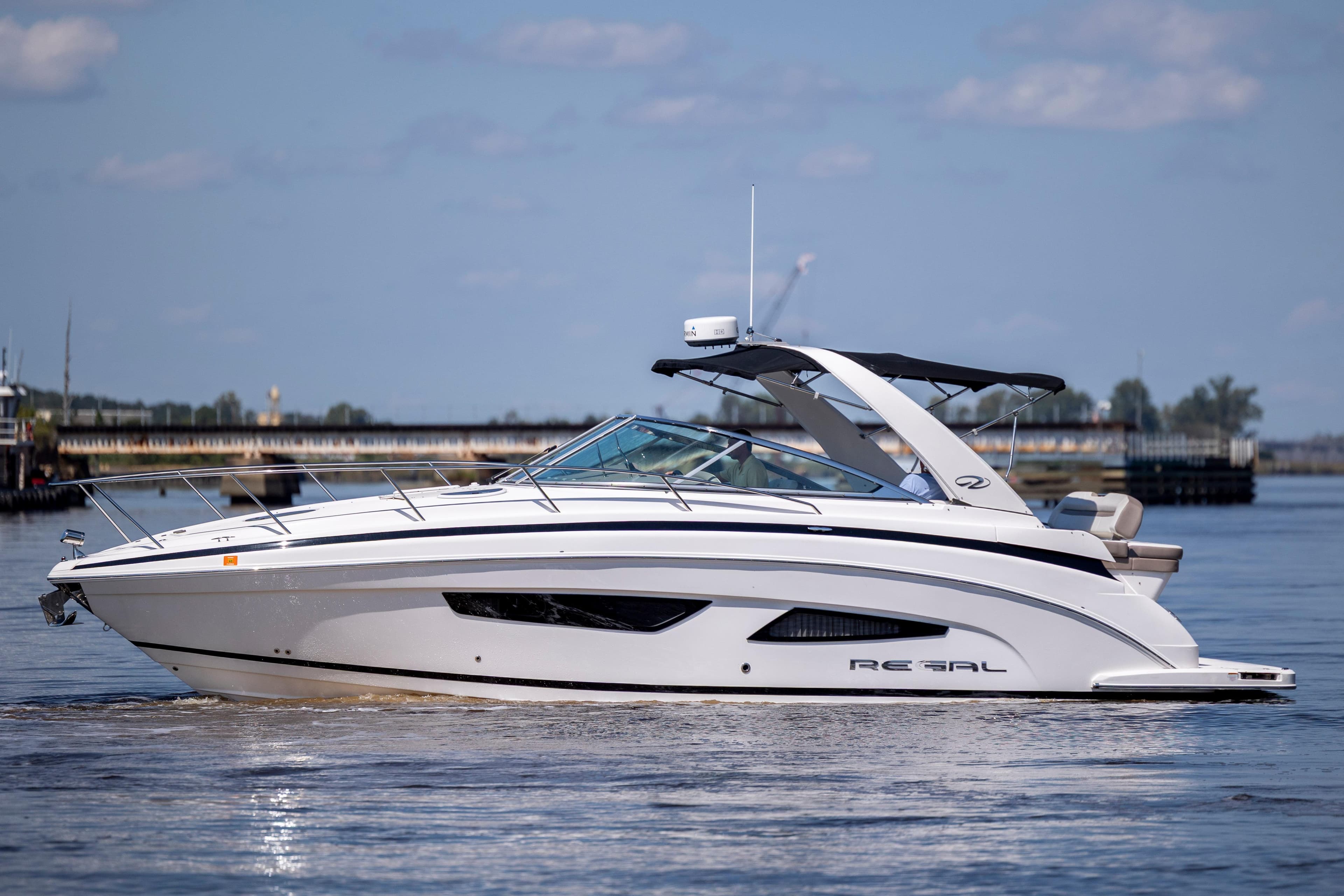 2017 Regal 32 Express boat cruising on calm water under a clear sky.