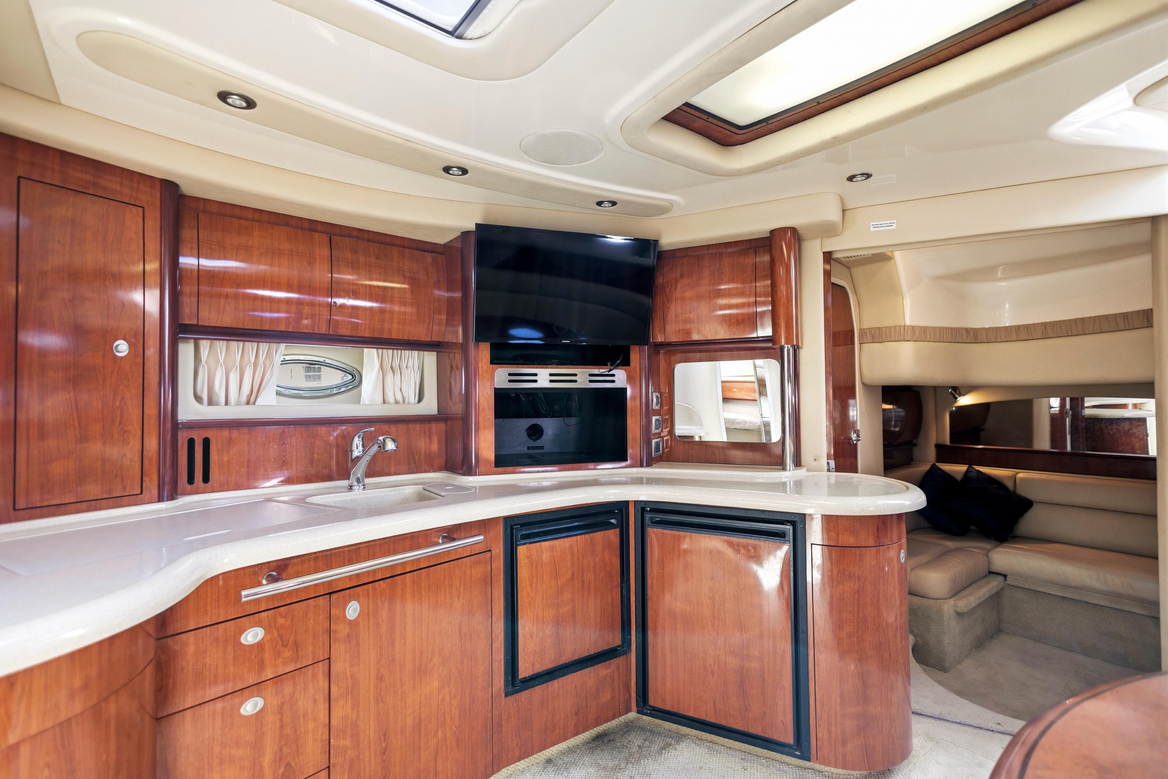 Luxurious interior of 2004 Sea Ray 420 Sundancer yacht with modern kitchen amenities.
