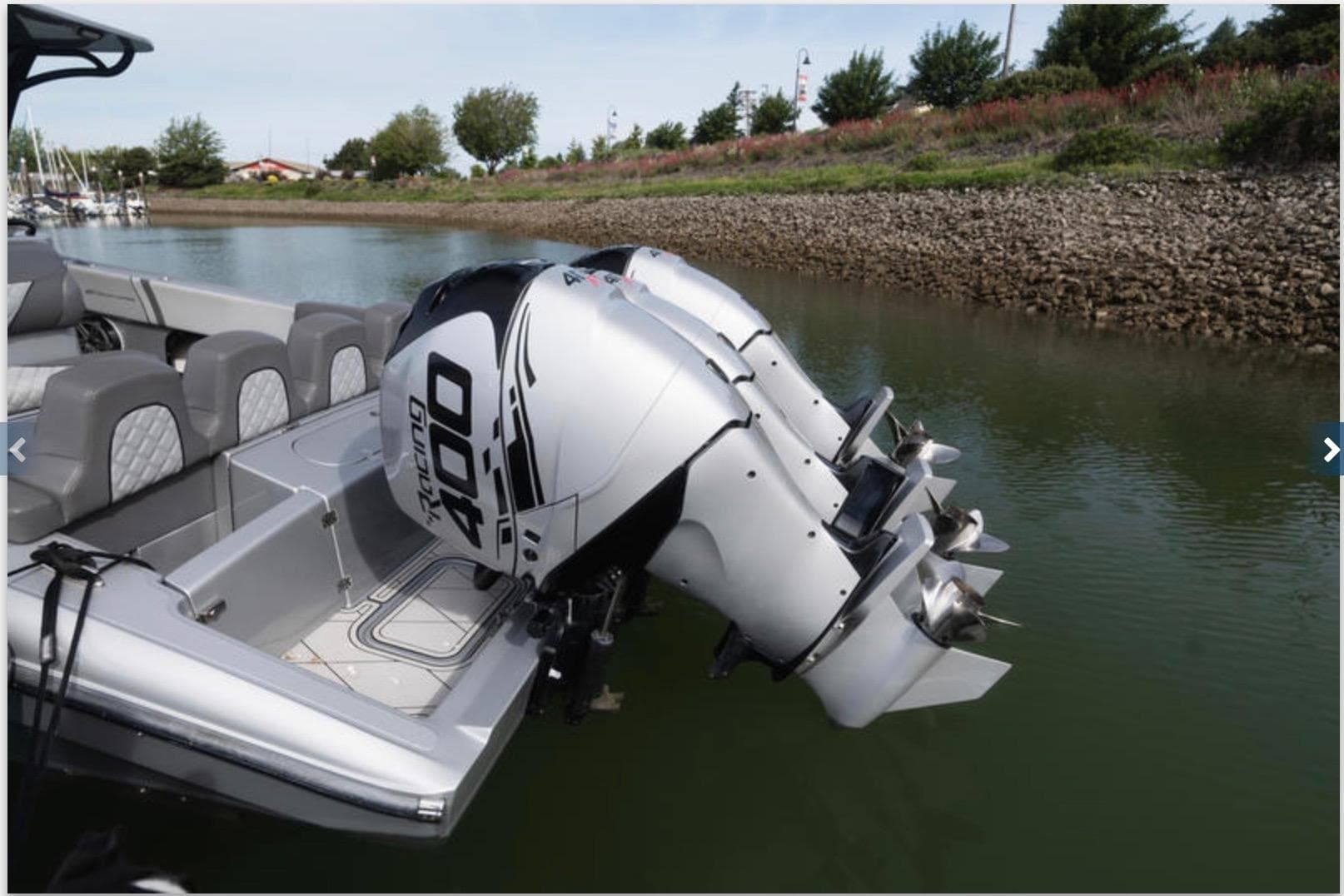 2020 Midnight Express 37 Open boat with dual outboard engines on a calm river.